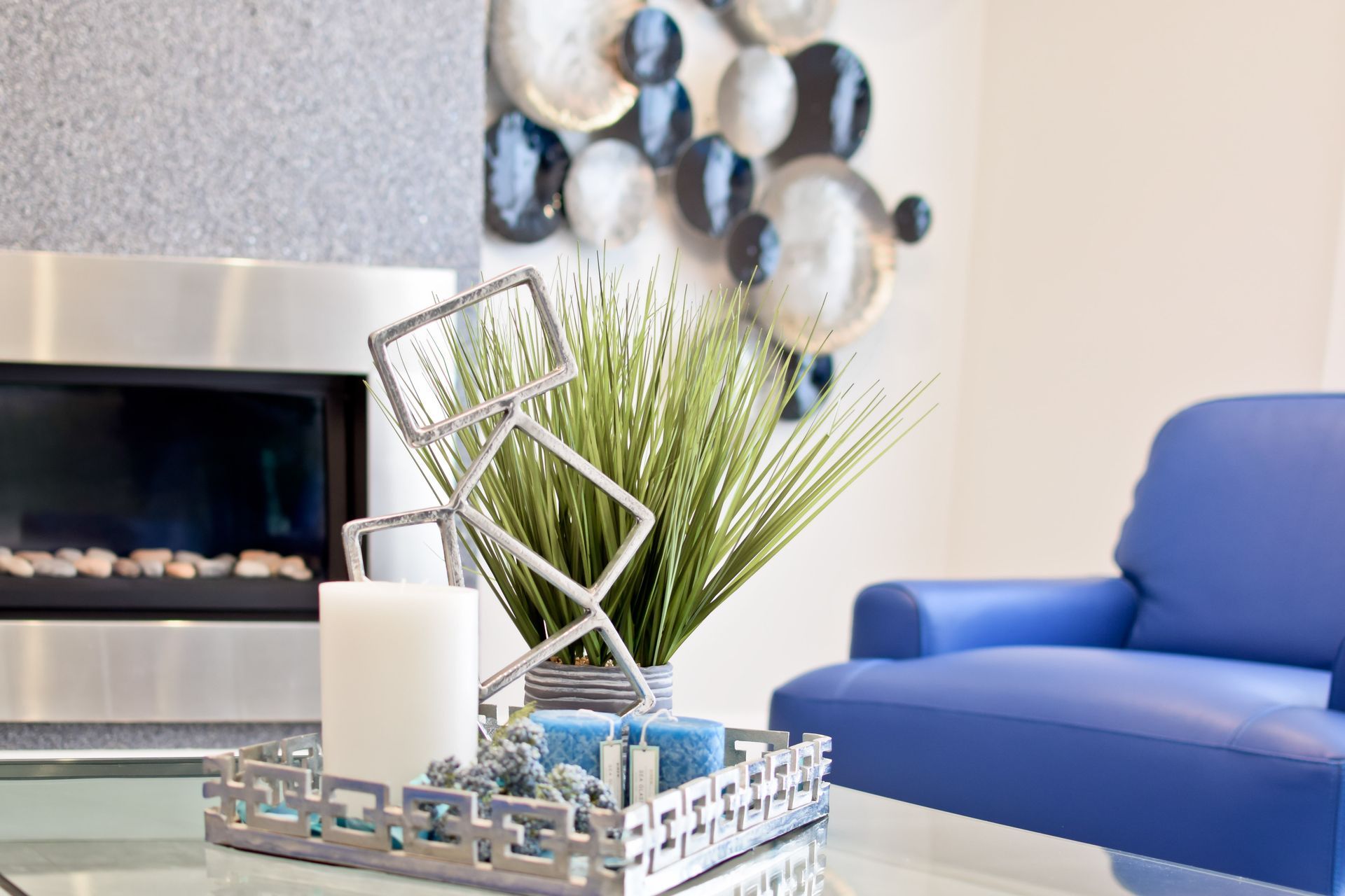 A living room with a fireplace and a blue chair