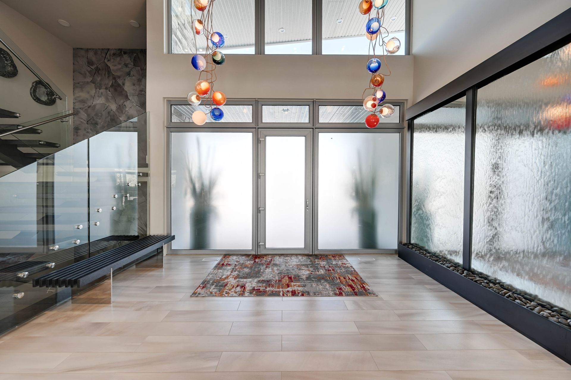 A large room with a lot of windows and a rug on the floor.