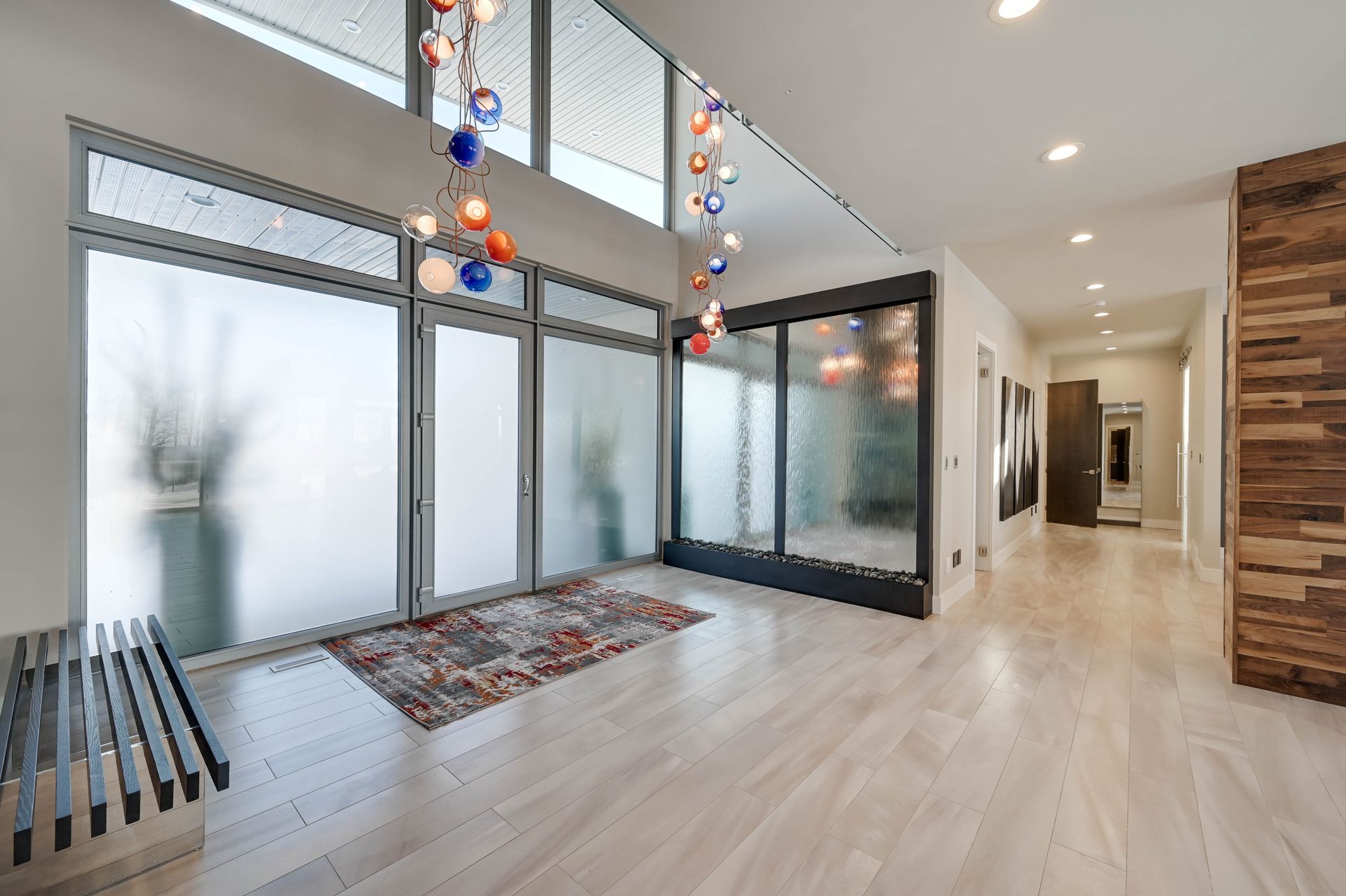A large room with a lot of windows and a chandelier hanging from the ceiling.