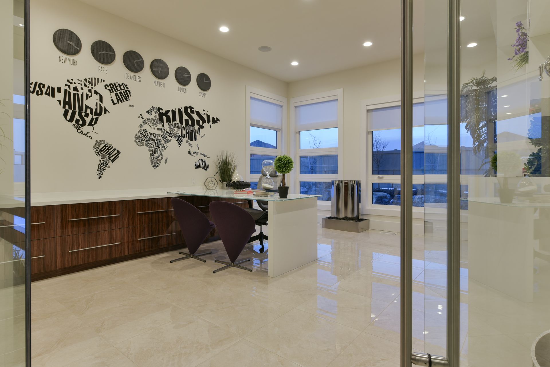 A modern office with a map of the world on the wall.