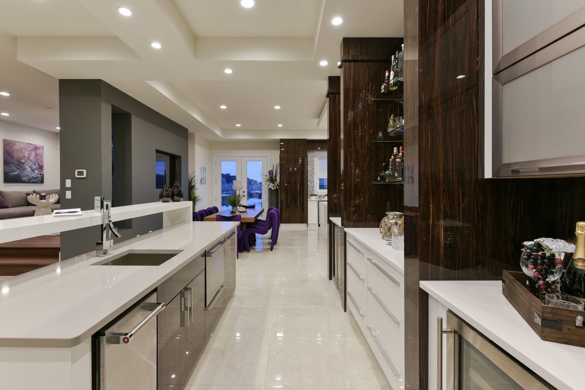 A kitchen with stainless steel appliances and white counter tops.