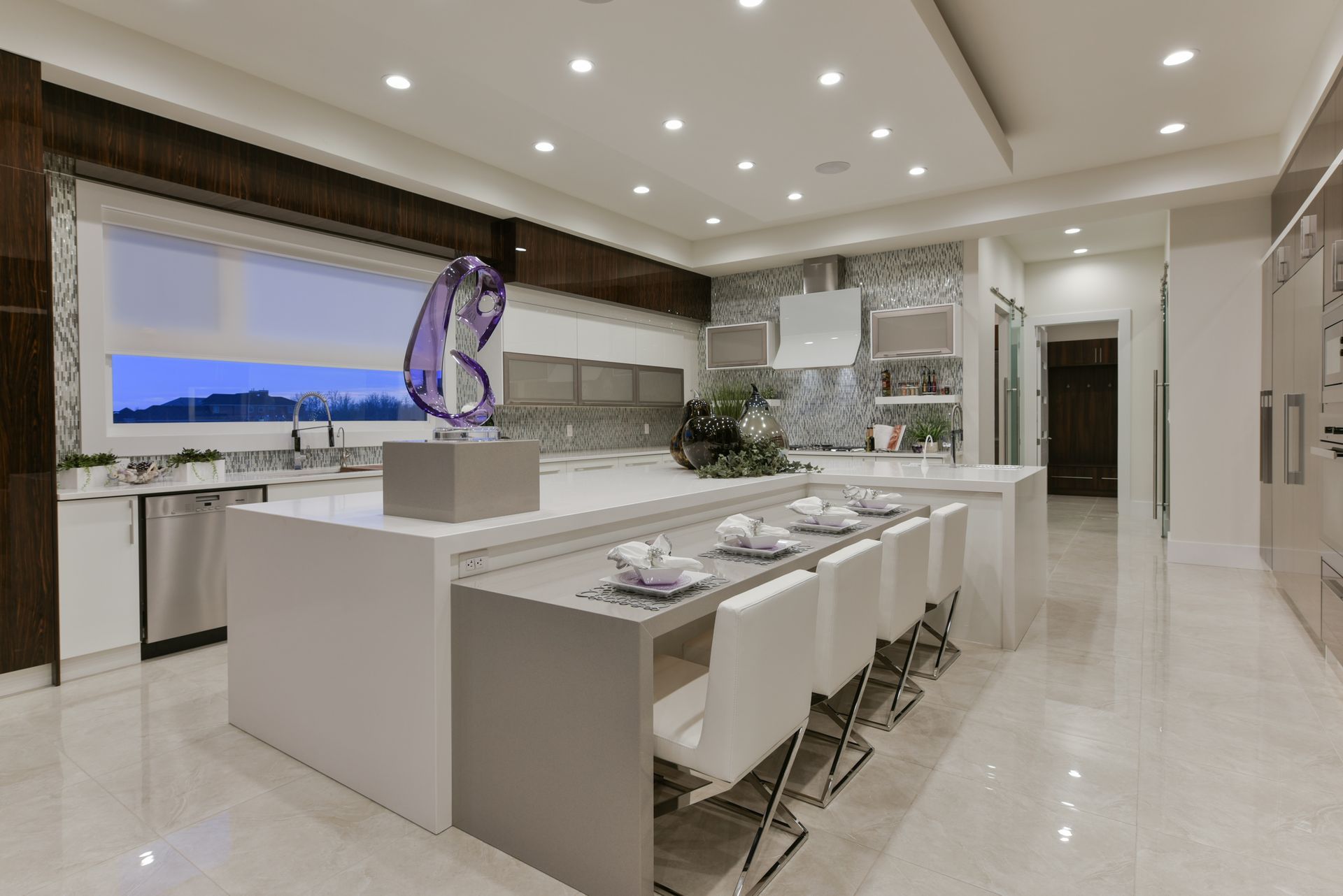 A large kitchen with a large island and a dining table.