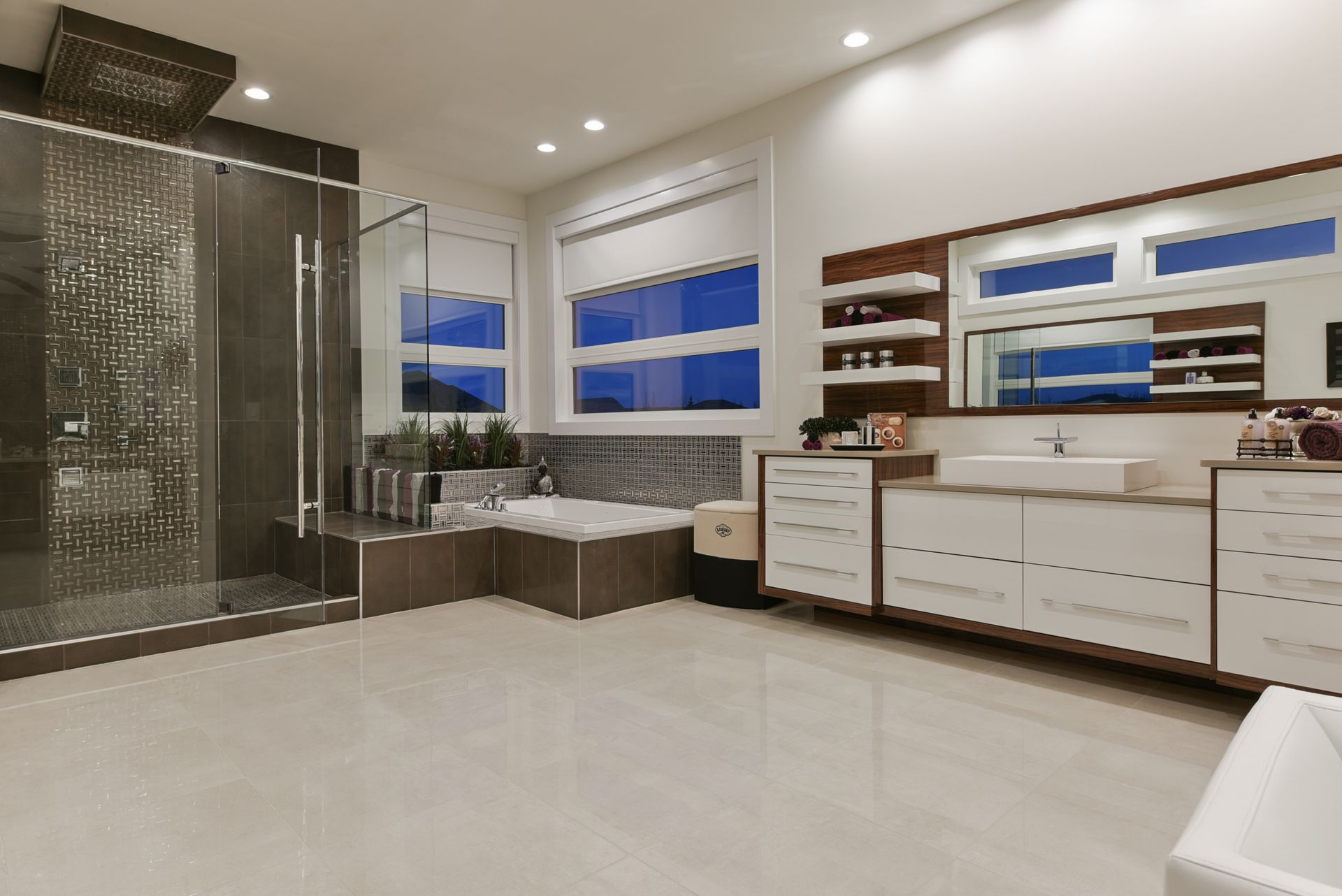 A bathroom with a tub , sink , mirror and shower.
