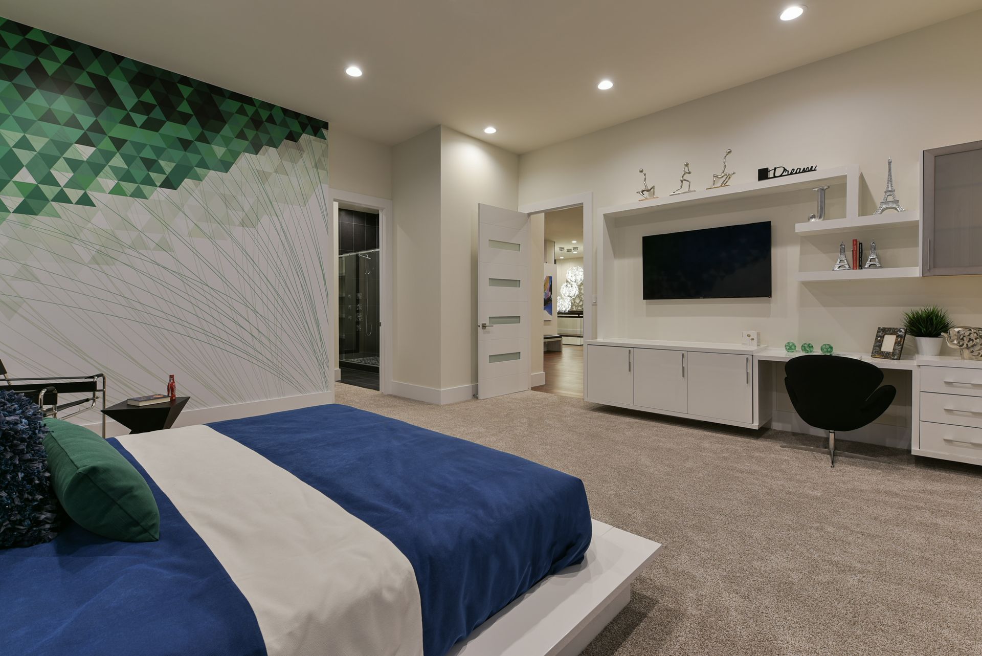 A bedroom with a bed and a television on the wall.