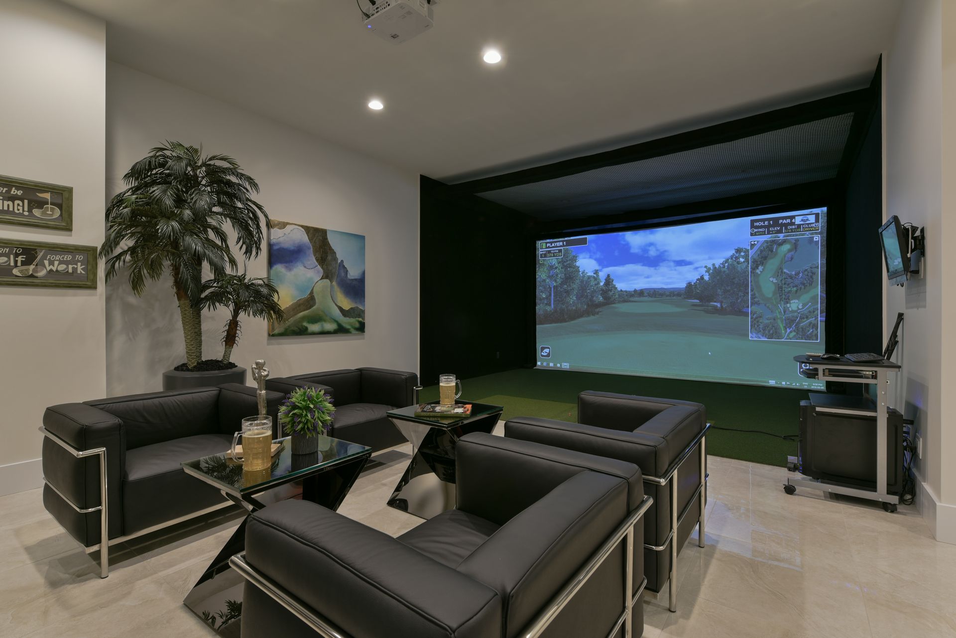 A living room with a golf simulator in the background