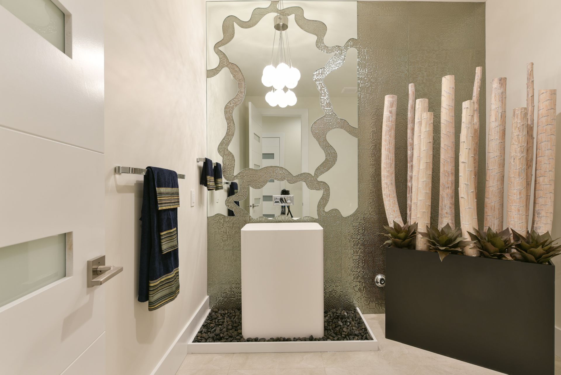 A bathroom with a sink and a large mirror