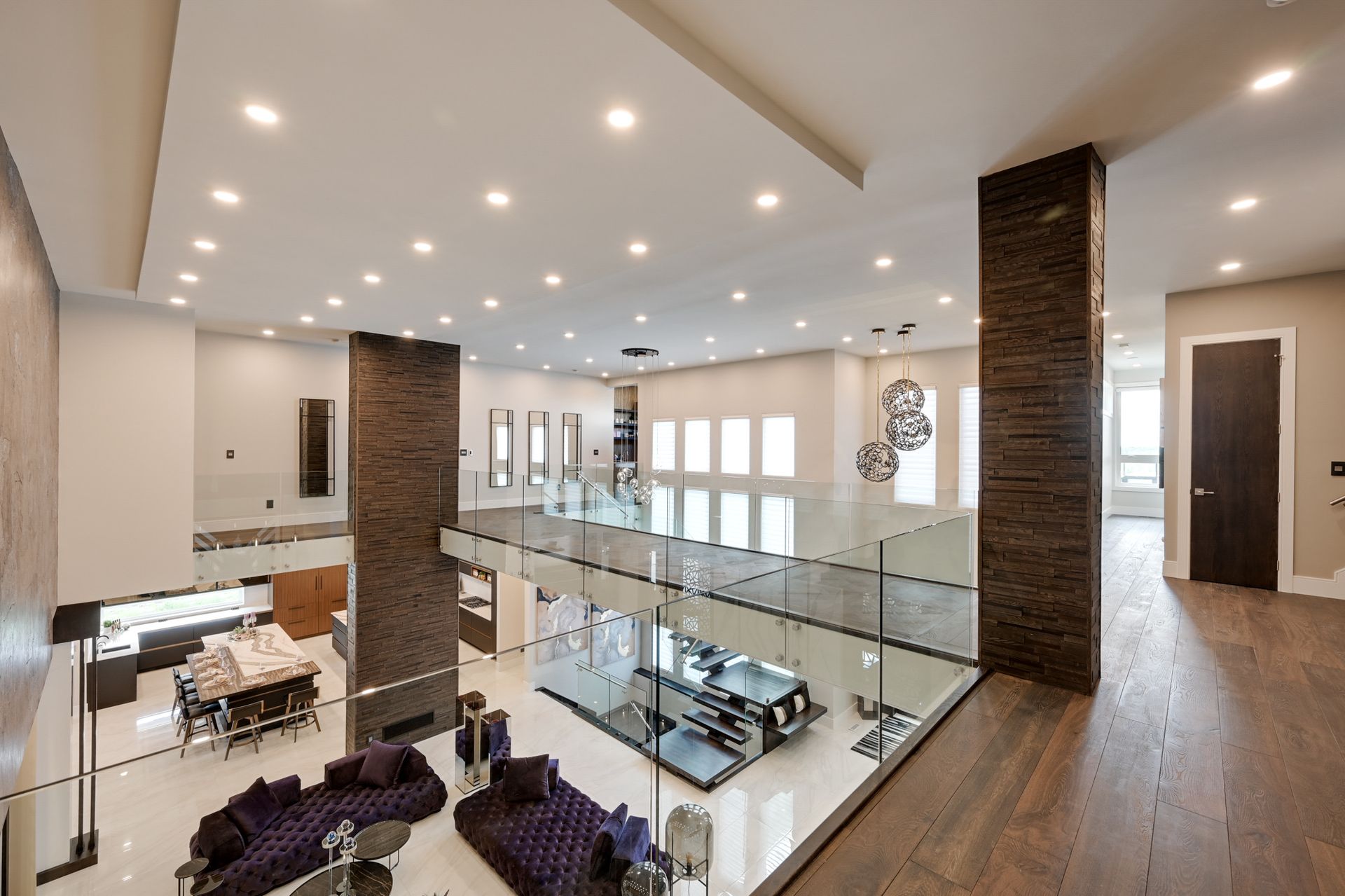 A living room with a purple couch and a glass railing