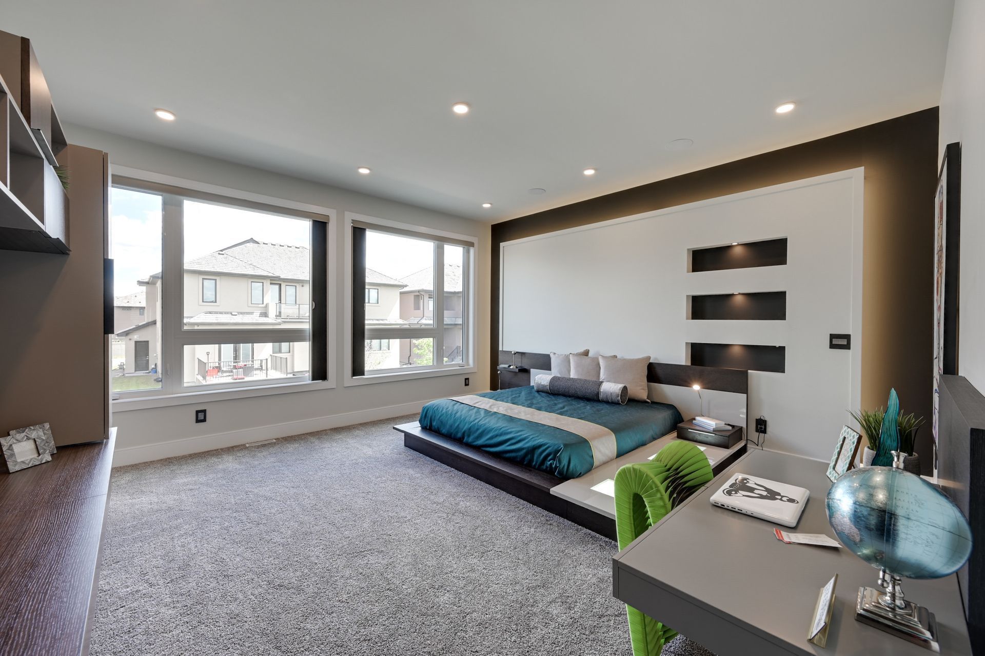 A bedroom with a large bed and a desk.