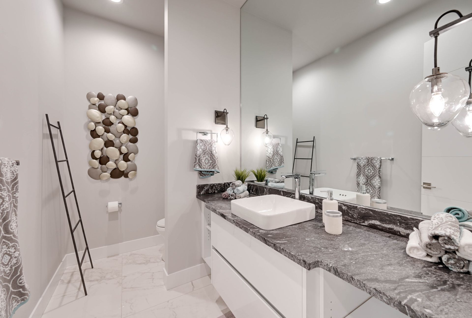 A bathroom with a sink , mirror and ladder.