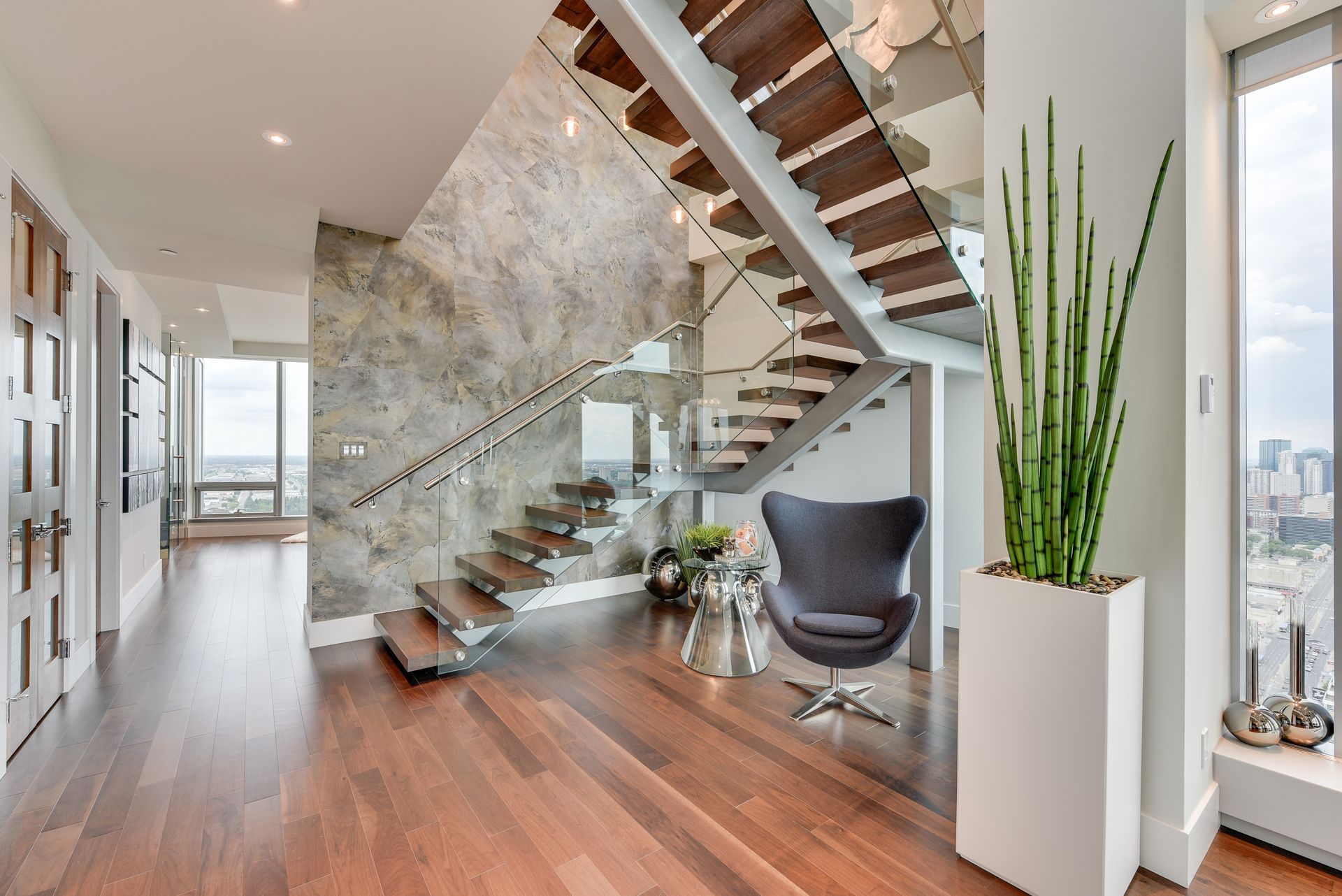 A living room with a staircase and a chair