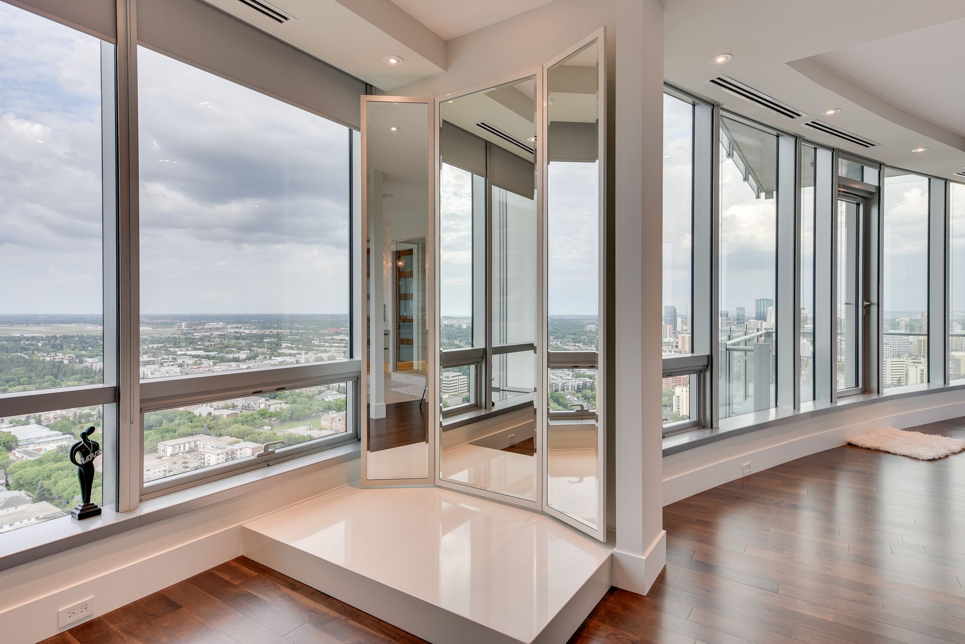 A room with a lot of windows and a large mirror