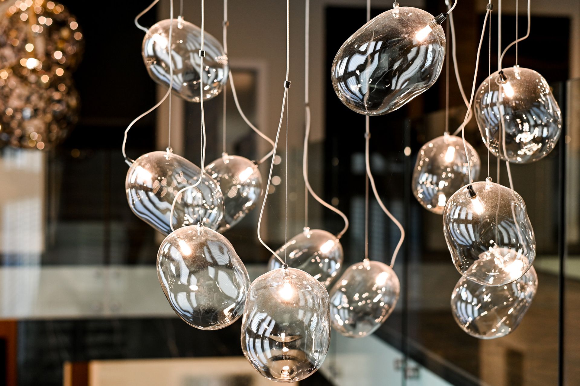 A bunch of clear glass balls hanging from the ceiling
