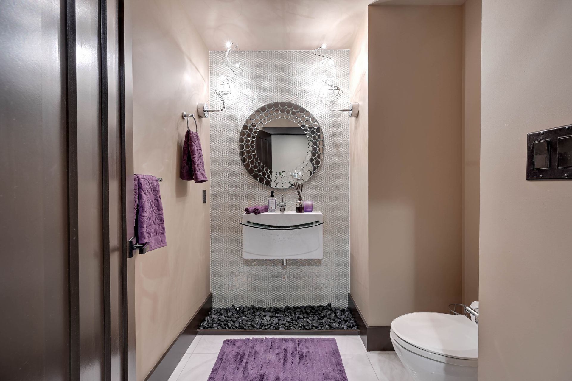 A bathroom with a sink , toilet , and mirror.
