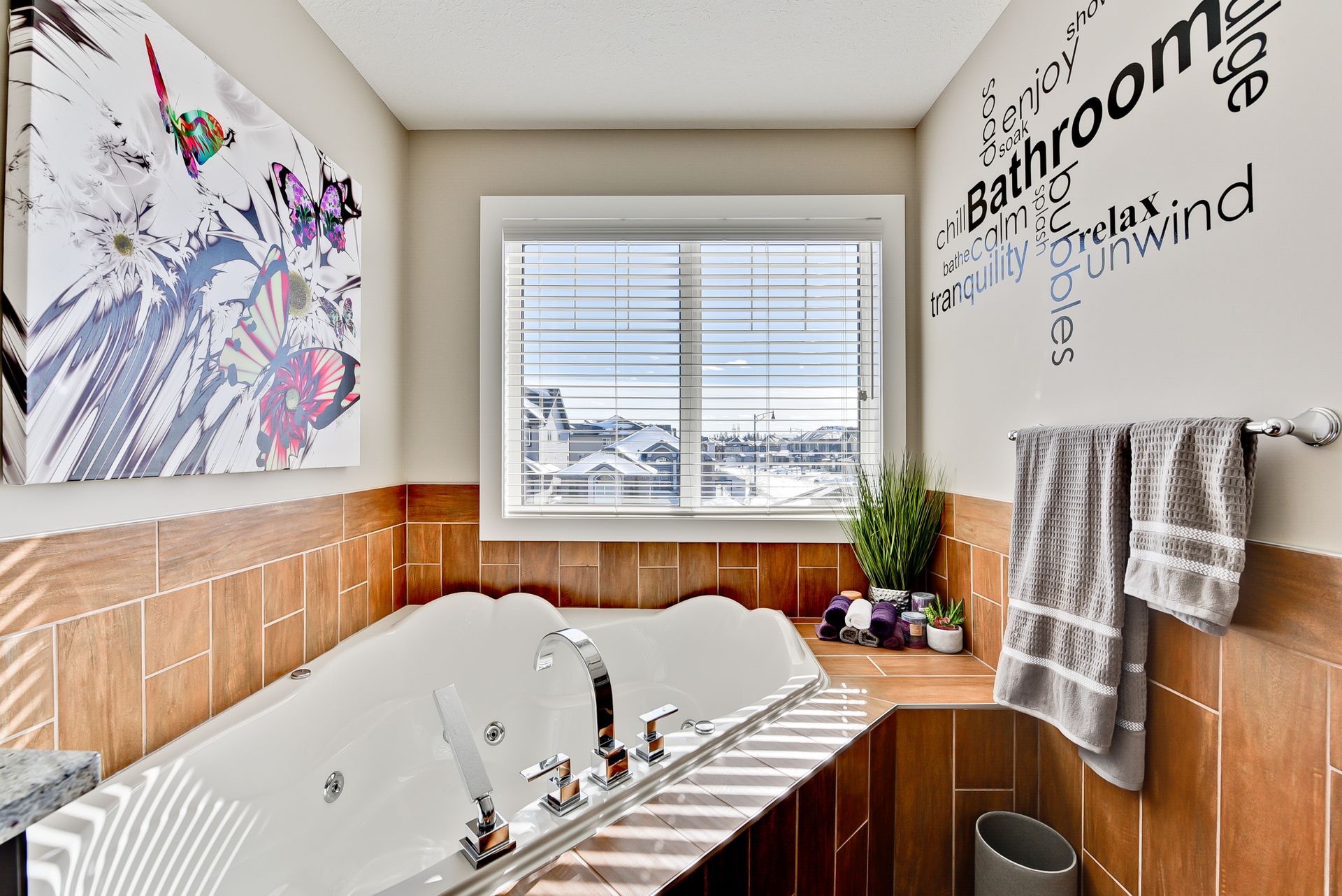 A bathroom with a jacuzzi tub and a window.