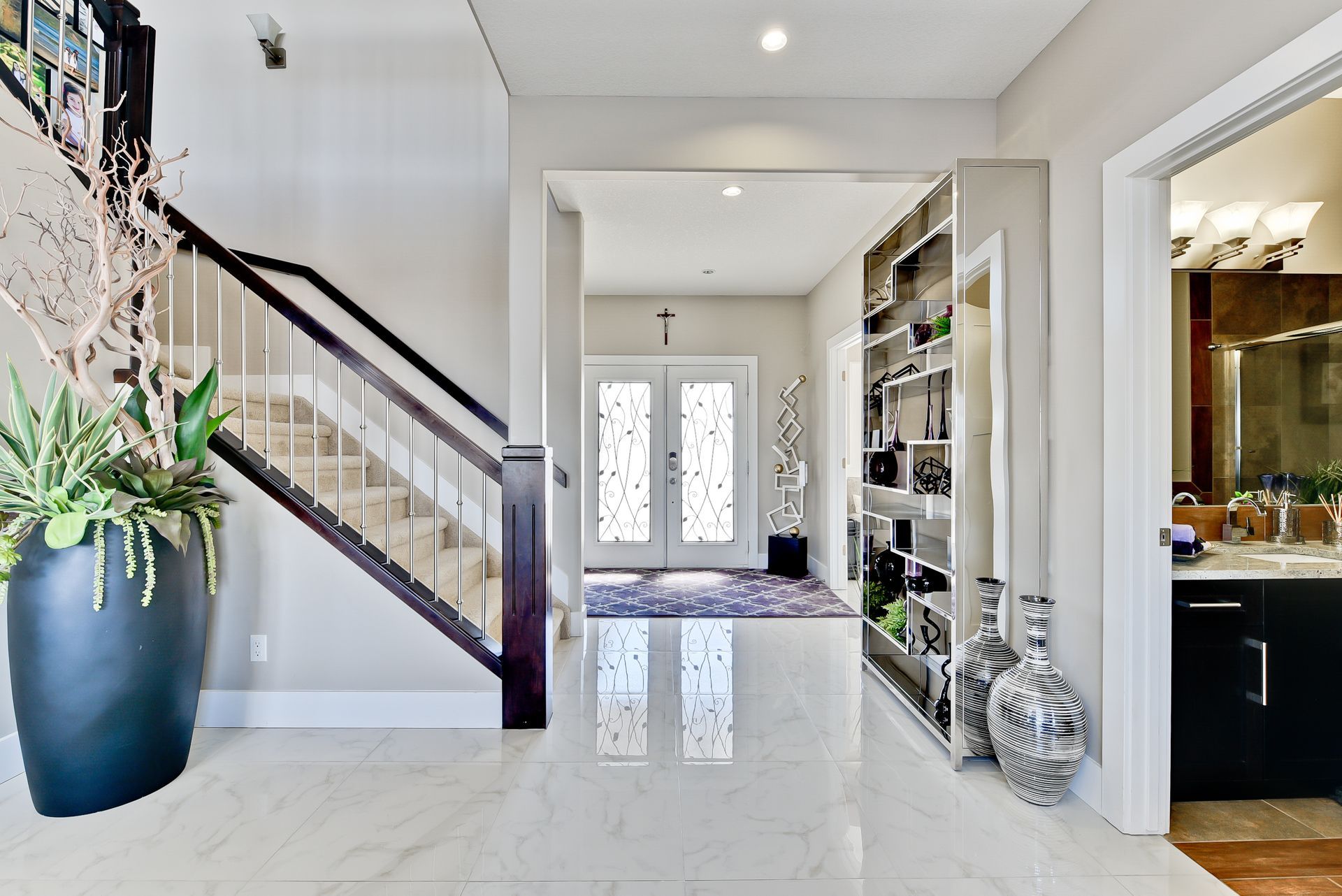 A hallway with stairs leading up to the second floor of a house