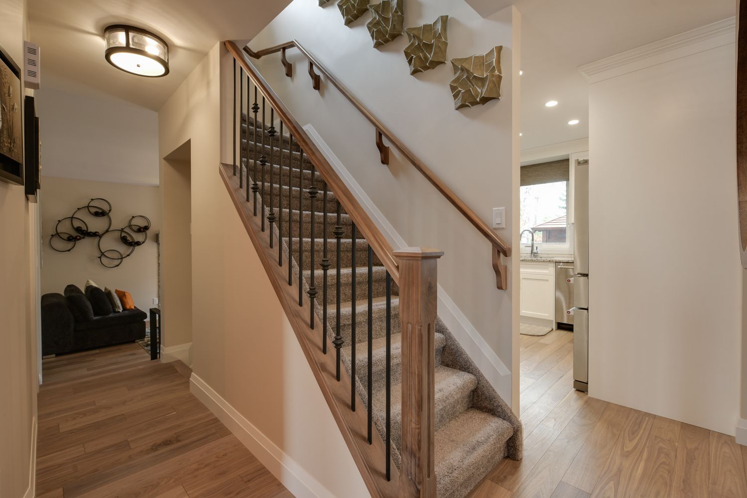 A hallway with stairs leading up to the second floor of a house.