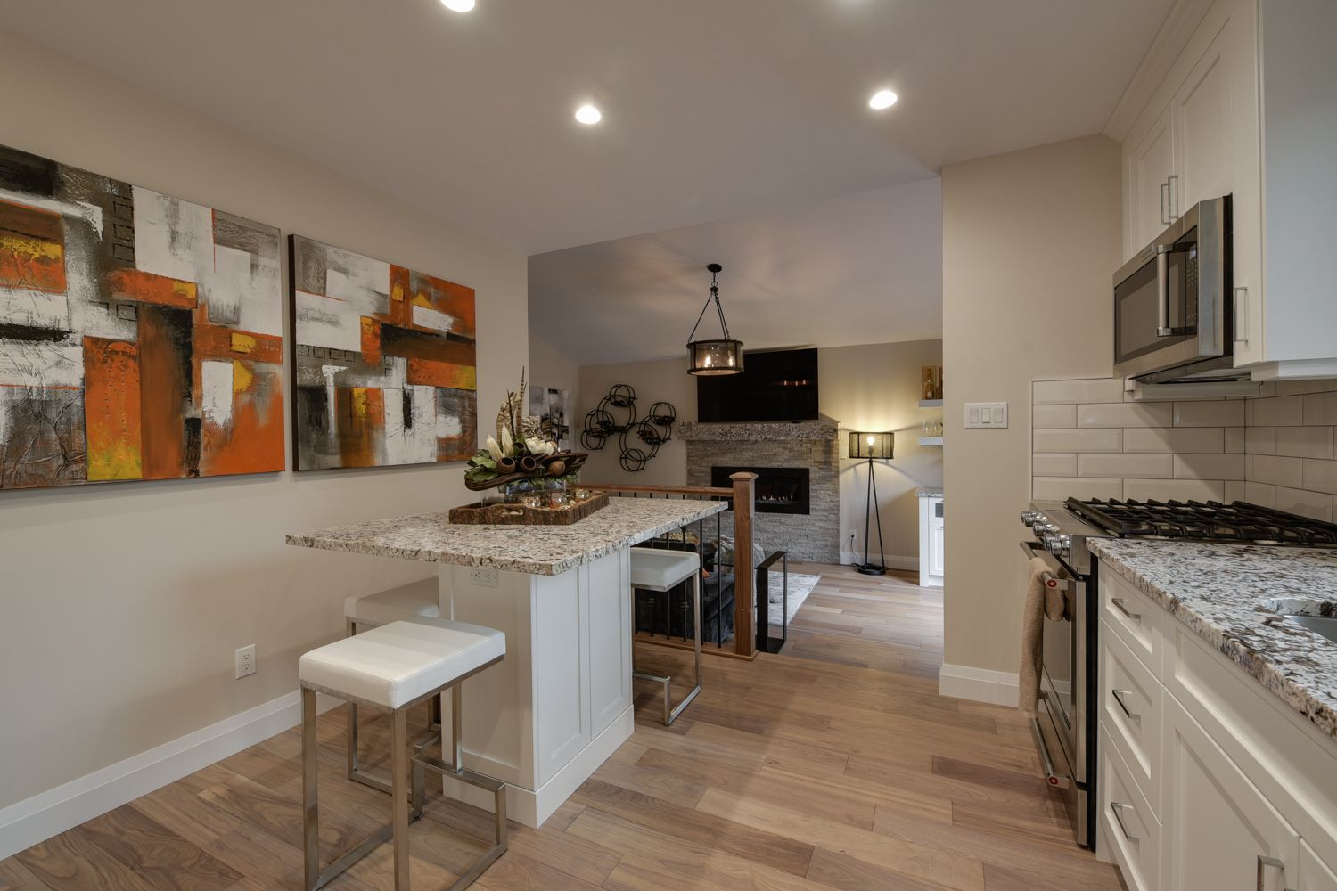 A kitchen with granite counter tops and stainless steel appliances.