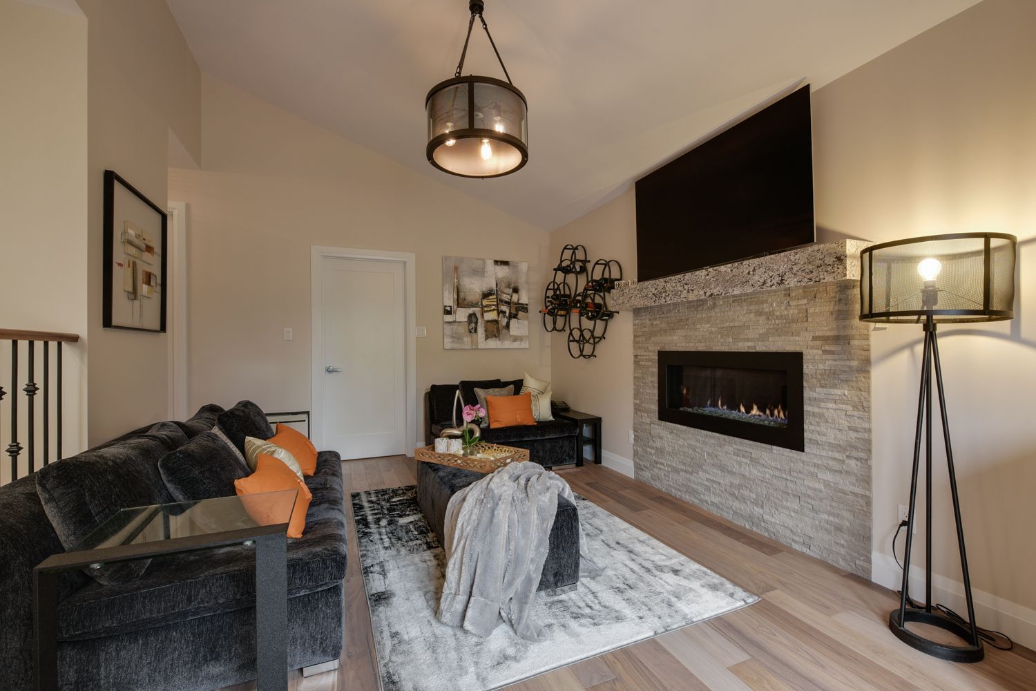 A living room with a fireplace , couch , chair and television.