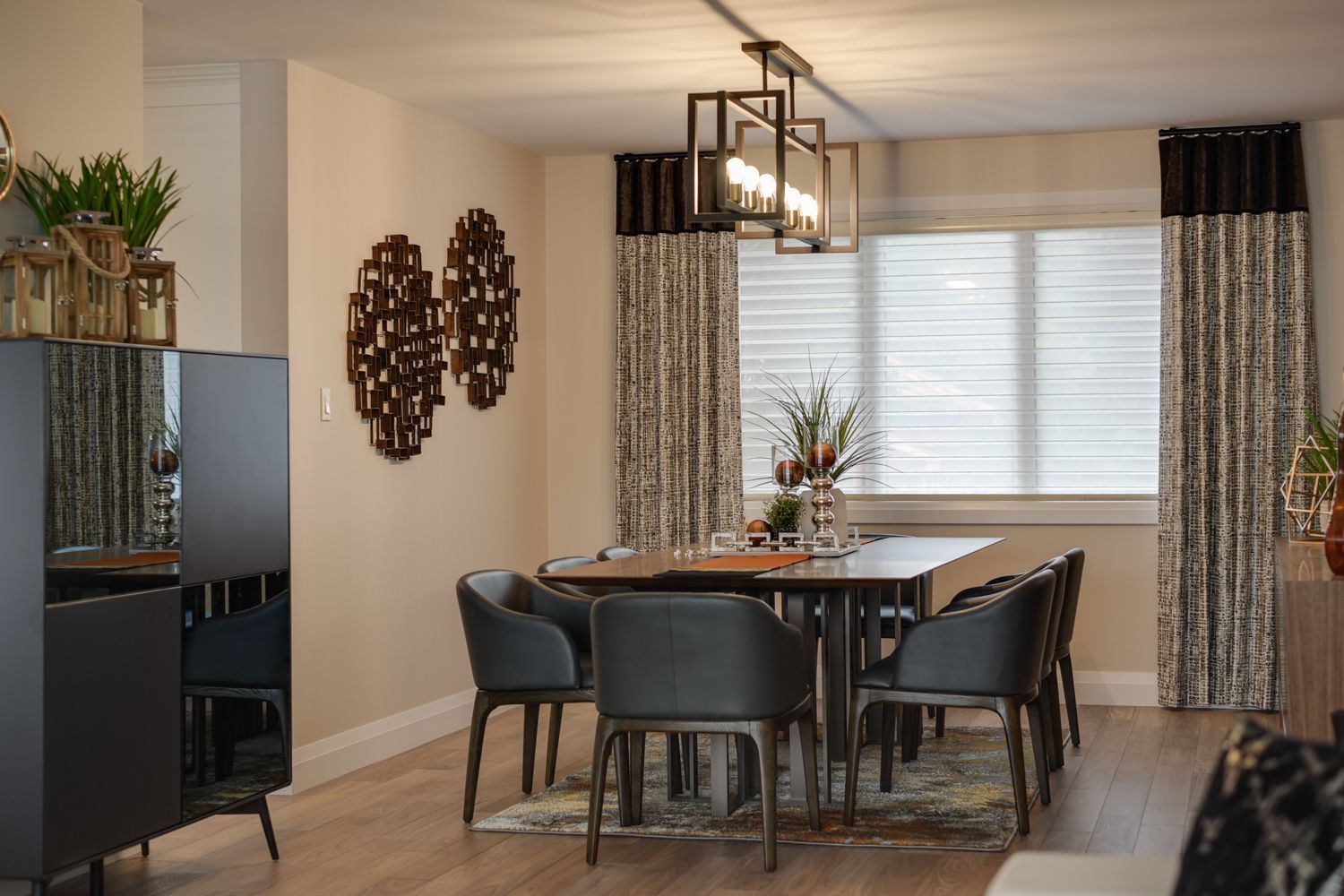 A dining room with a table and chairs and a window
