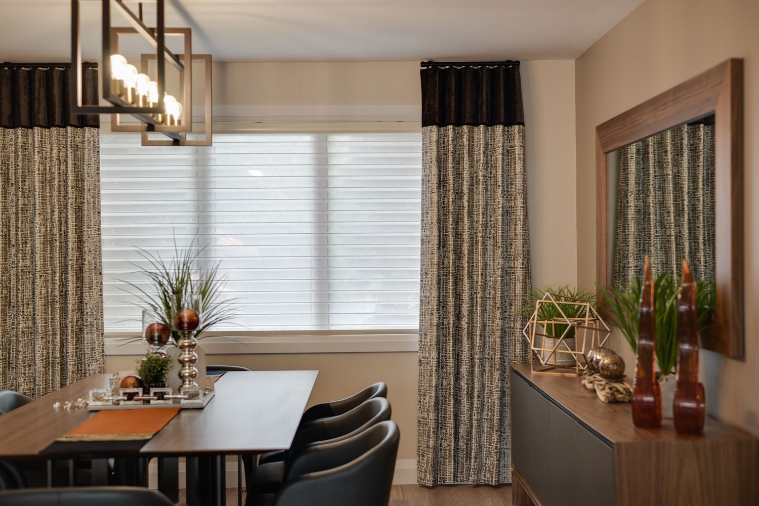 A dining room with a table and chairs and a mirror