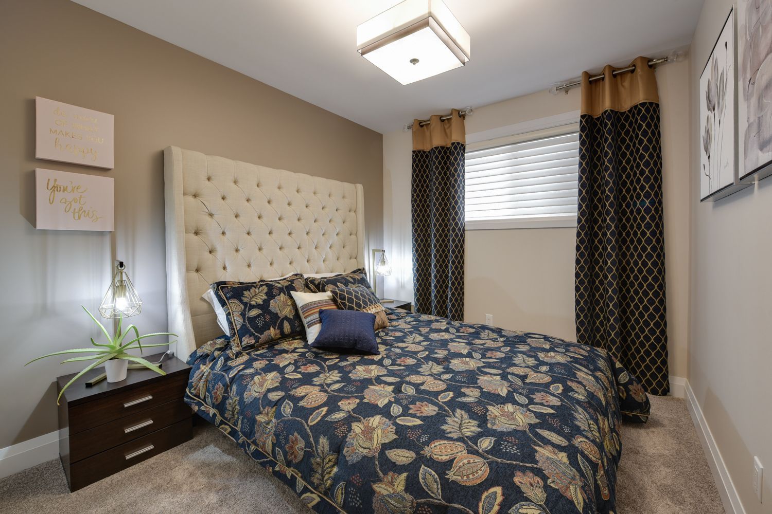 A bedroom with a large bed and a nightstand