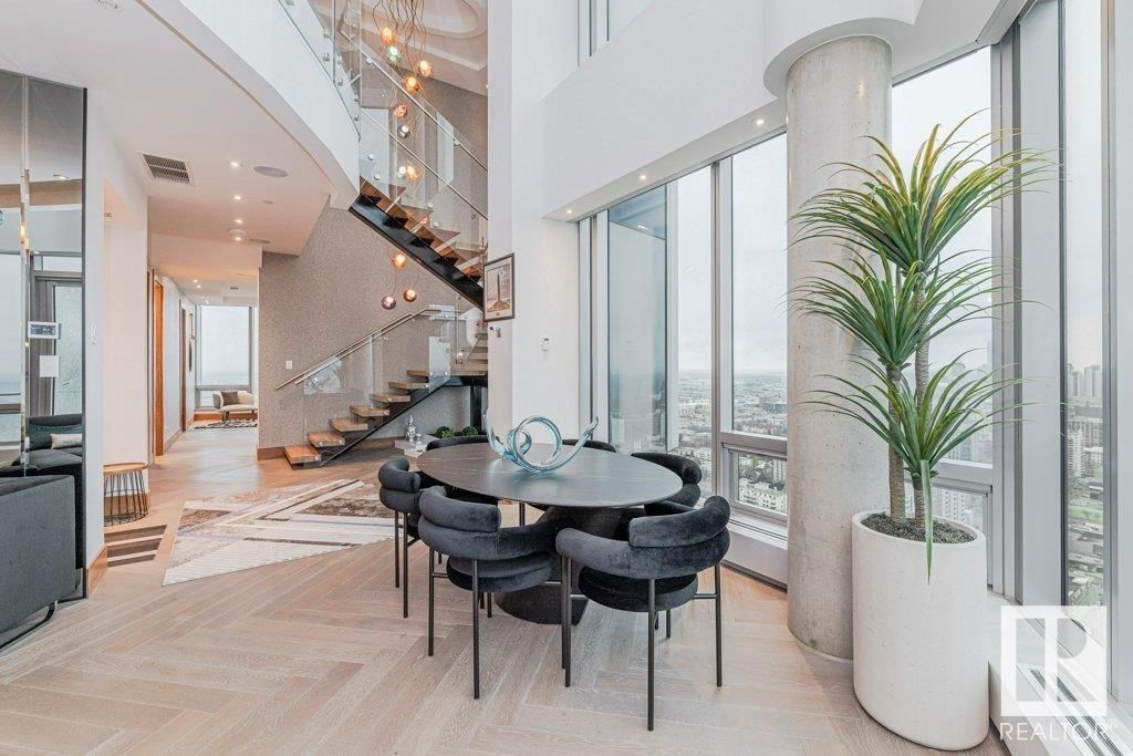 There is a table and chairs in the middle of the room.
