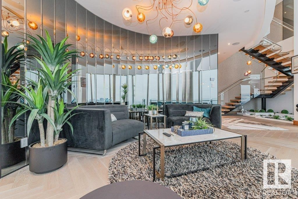 A living room with a couch , coffee table , and stairs.