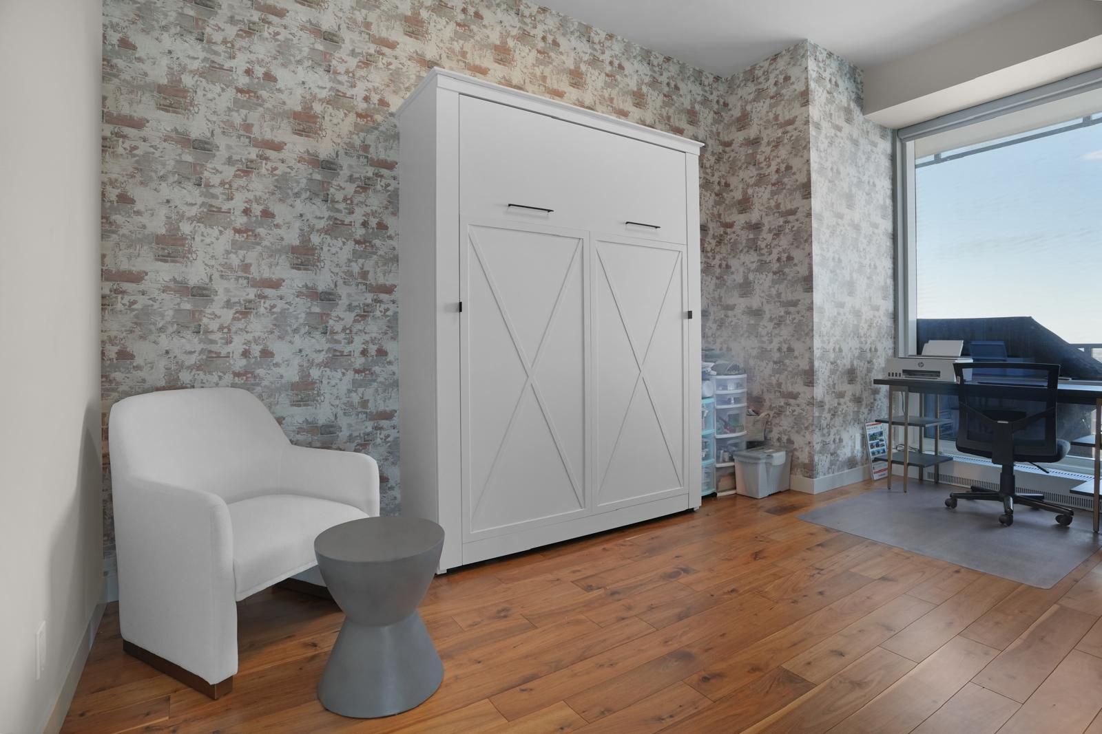 There is a chair and a desk in the room.