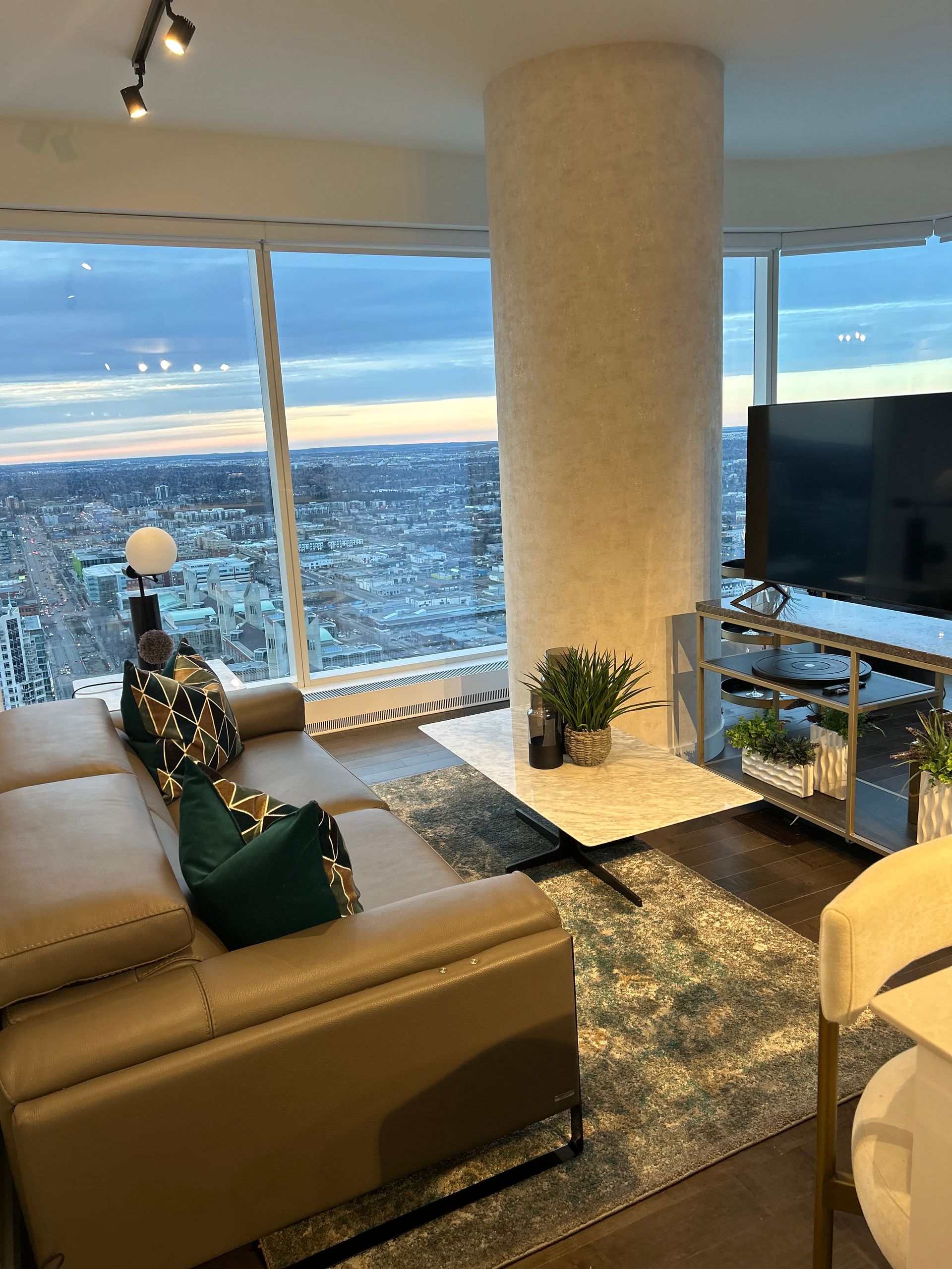A living room with a couch , table , and television.