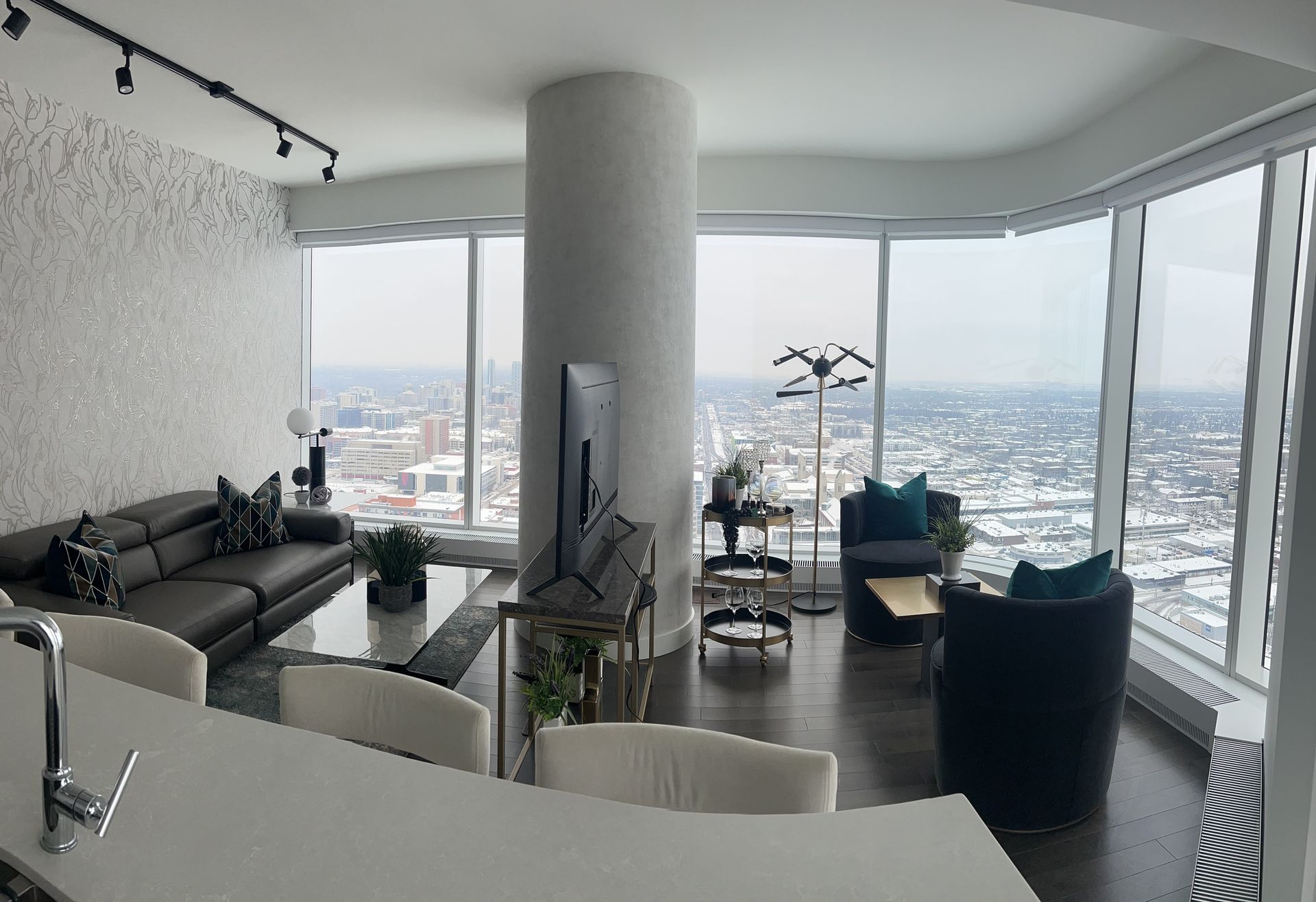 A living room with a couch , chairs and a television
