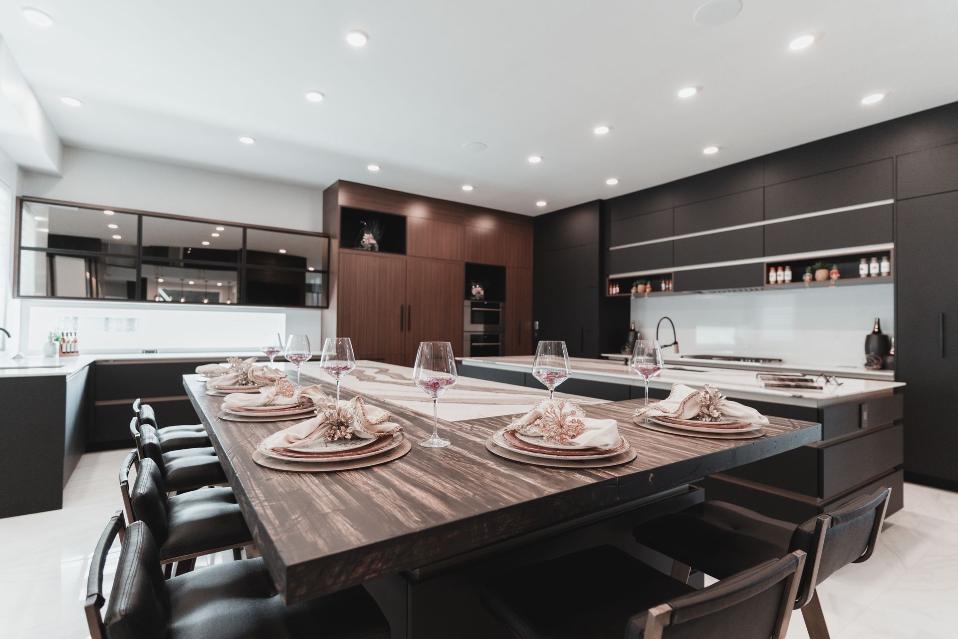 A large kitchen with a long wooden table and chairs.