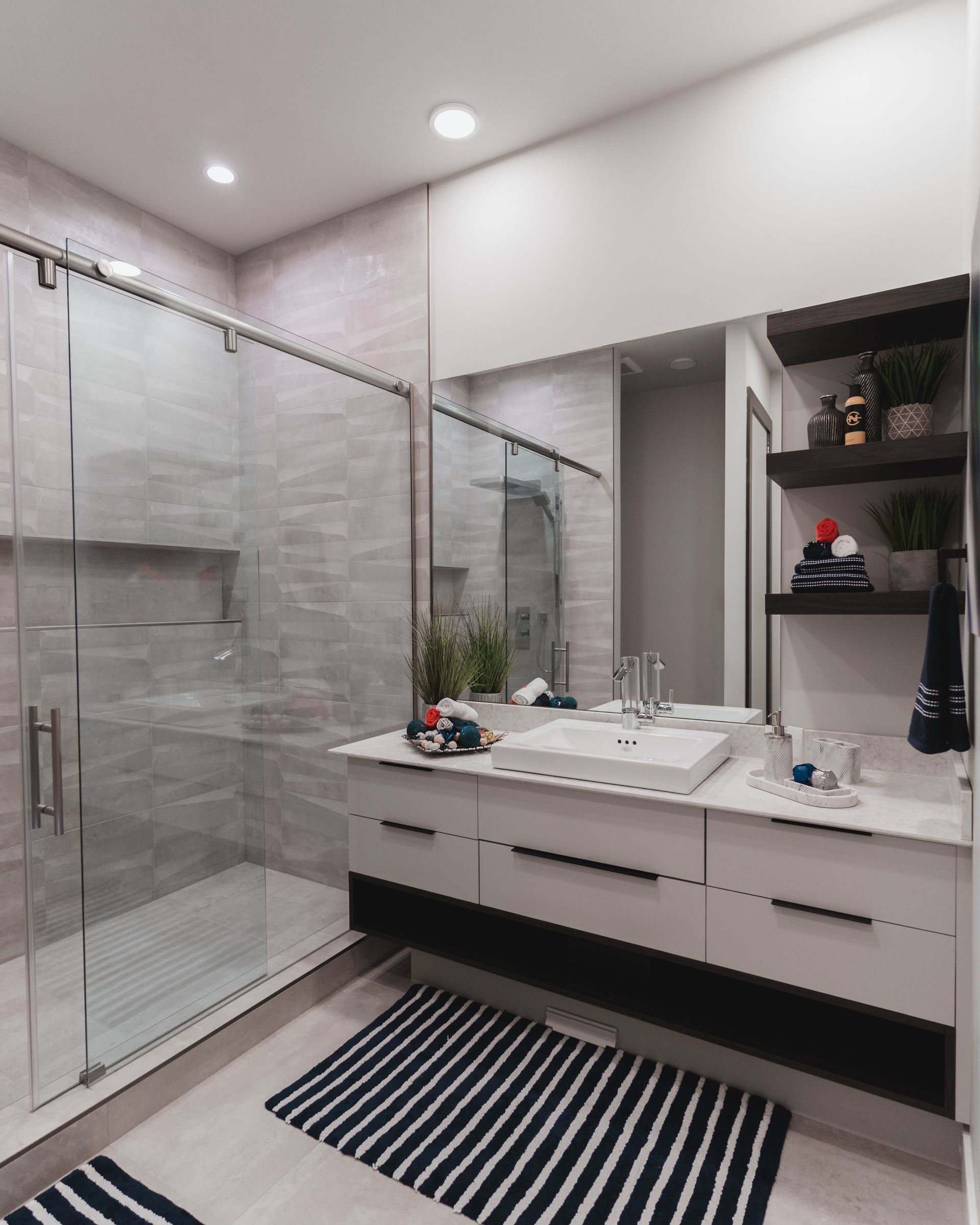 A bathroom with a sink and a walk in shower