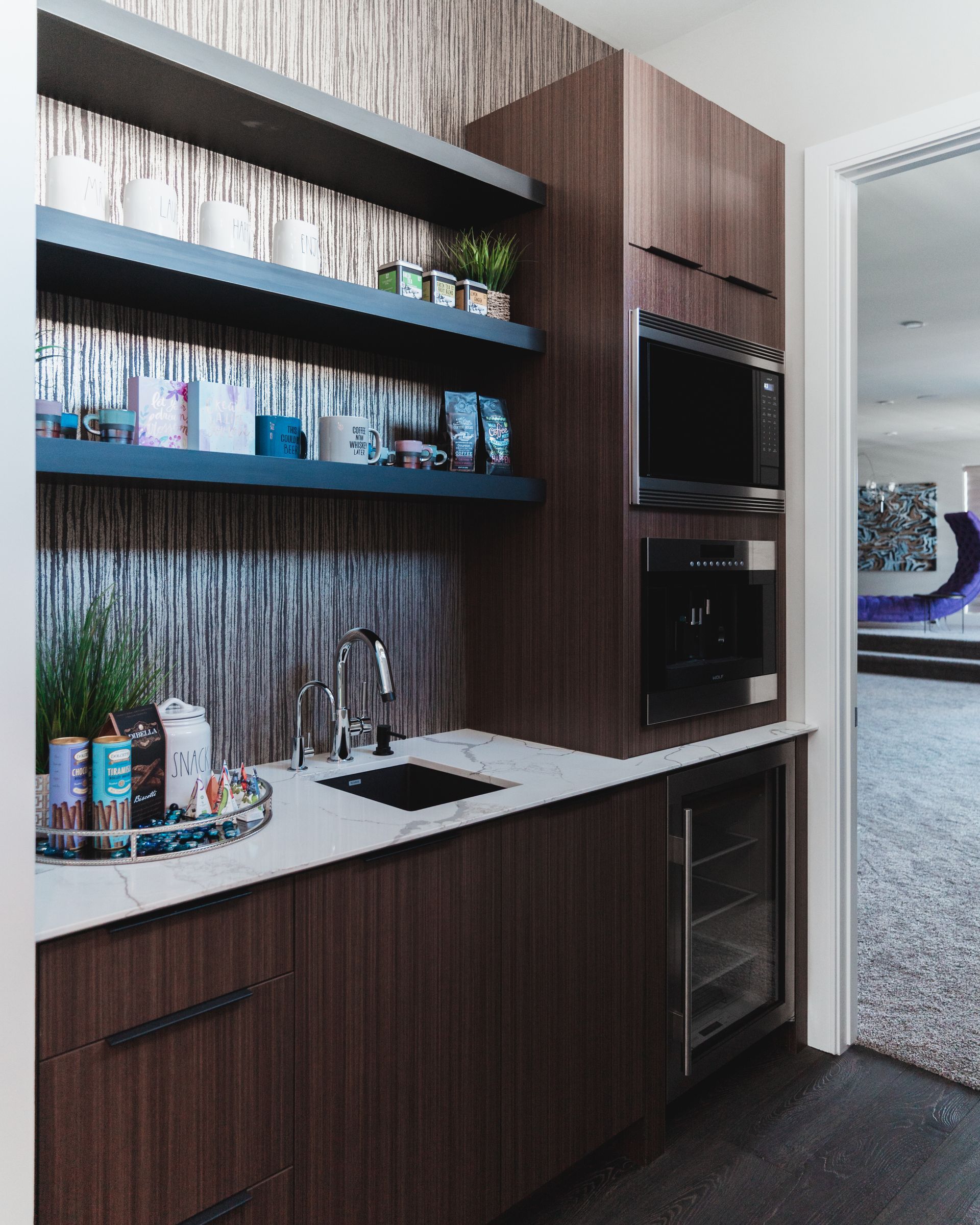 A kitchen with wooden cabinets , a sink , and a refrigerator.