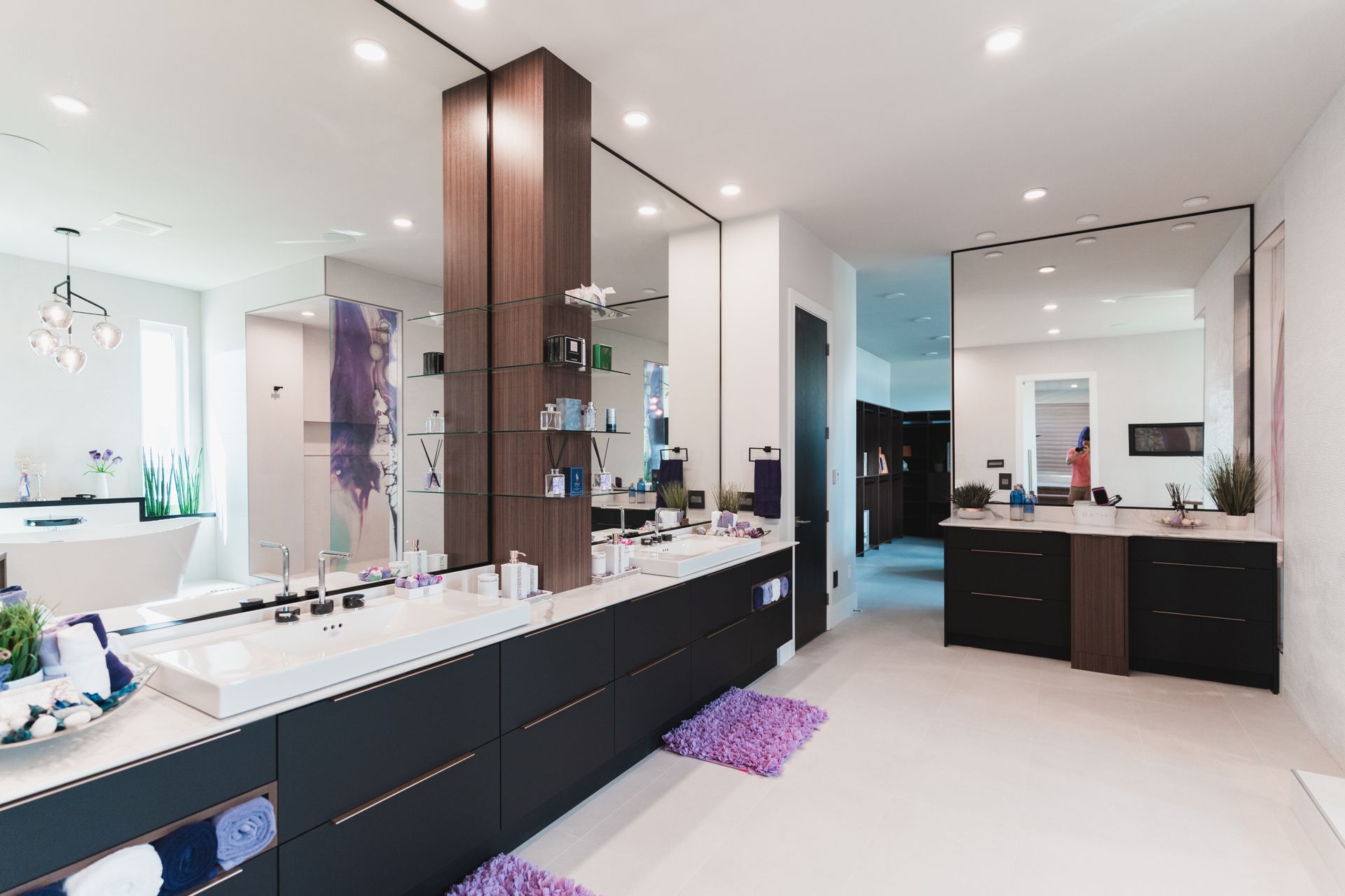 A bathroom with two sinks and a large mirror.