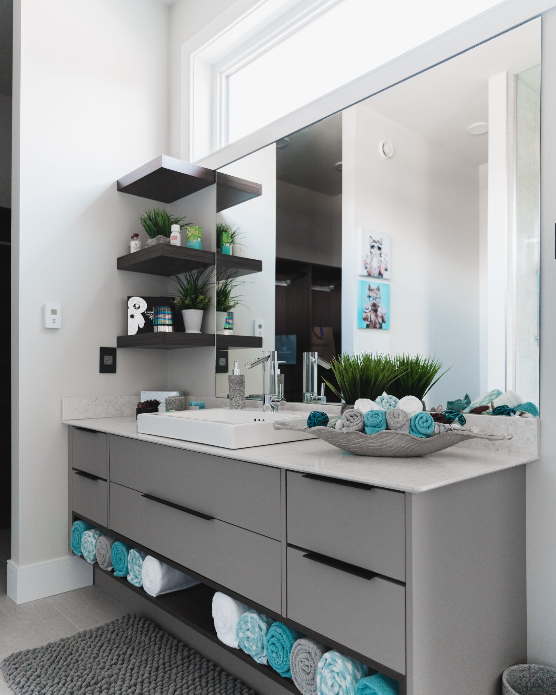 A bathroom with a sink and a large mirror