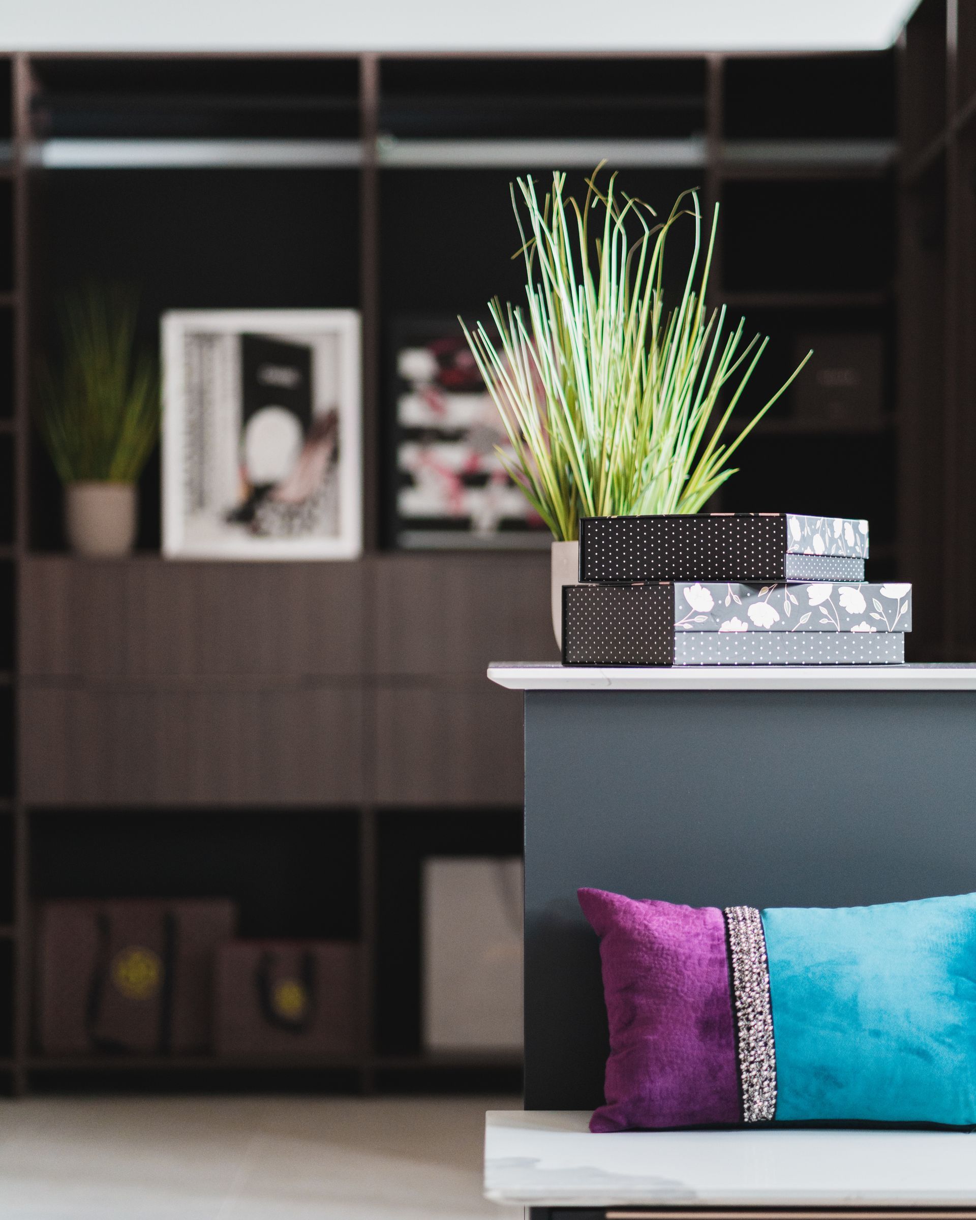 A purple and blue pillow sits on a table in a living room