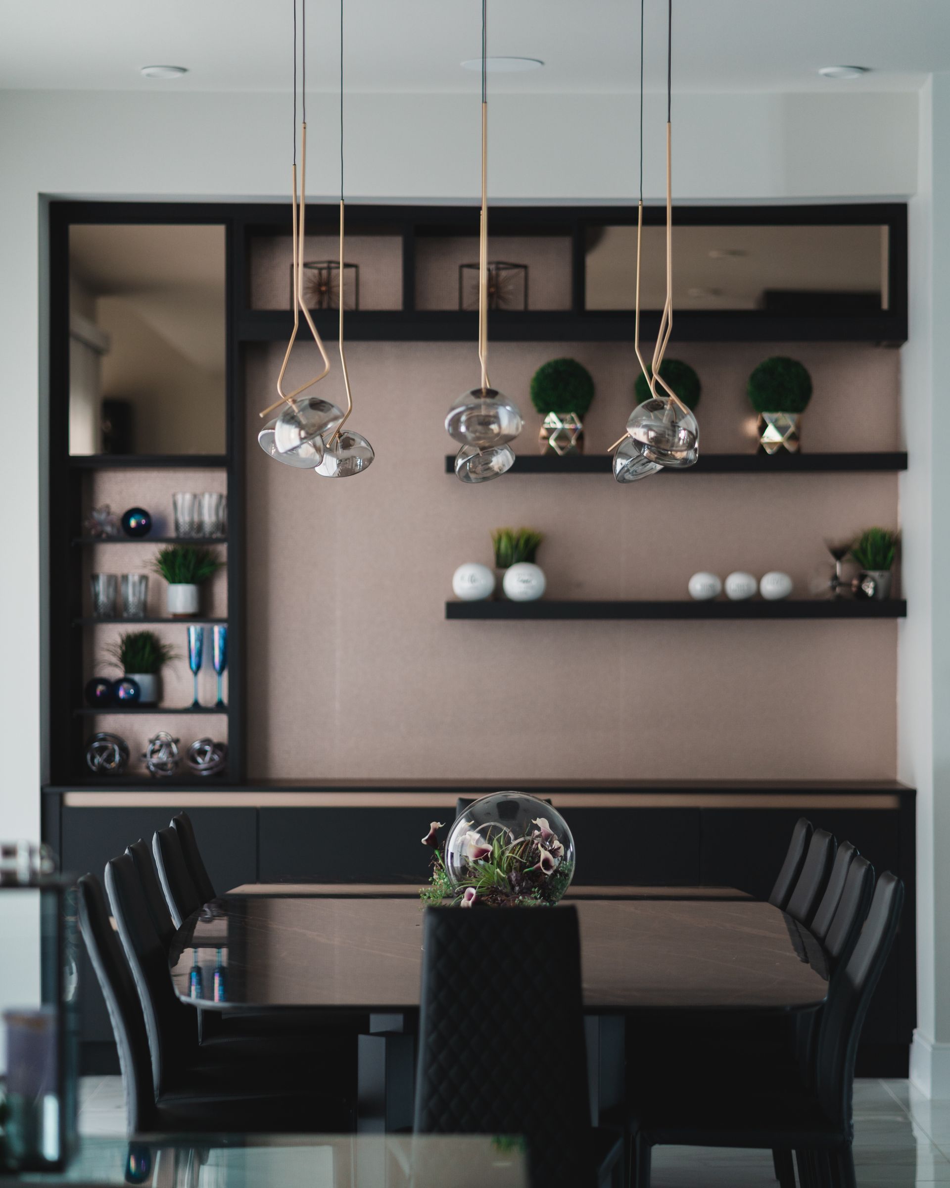 A dining room with a table and chairs and shelves