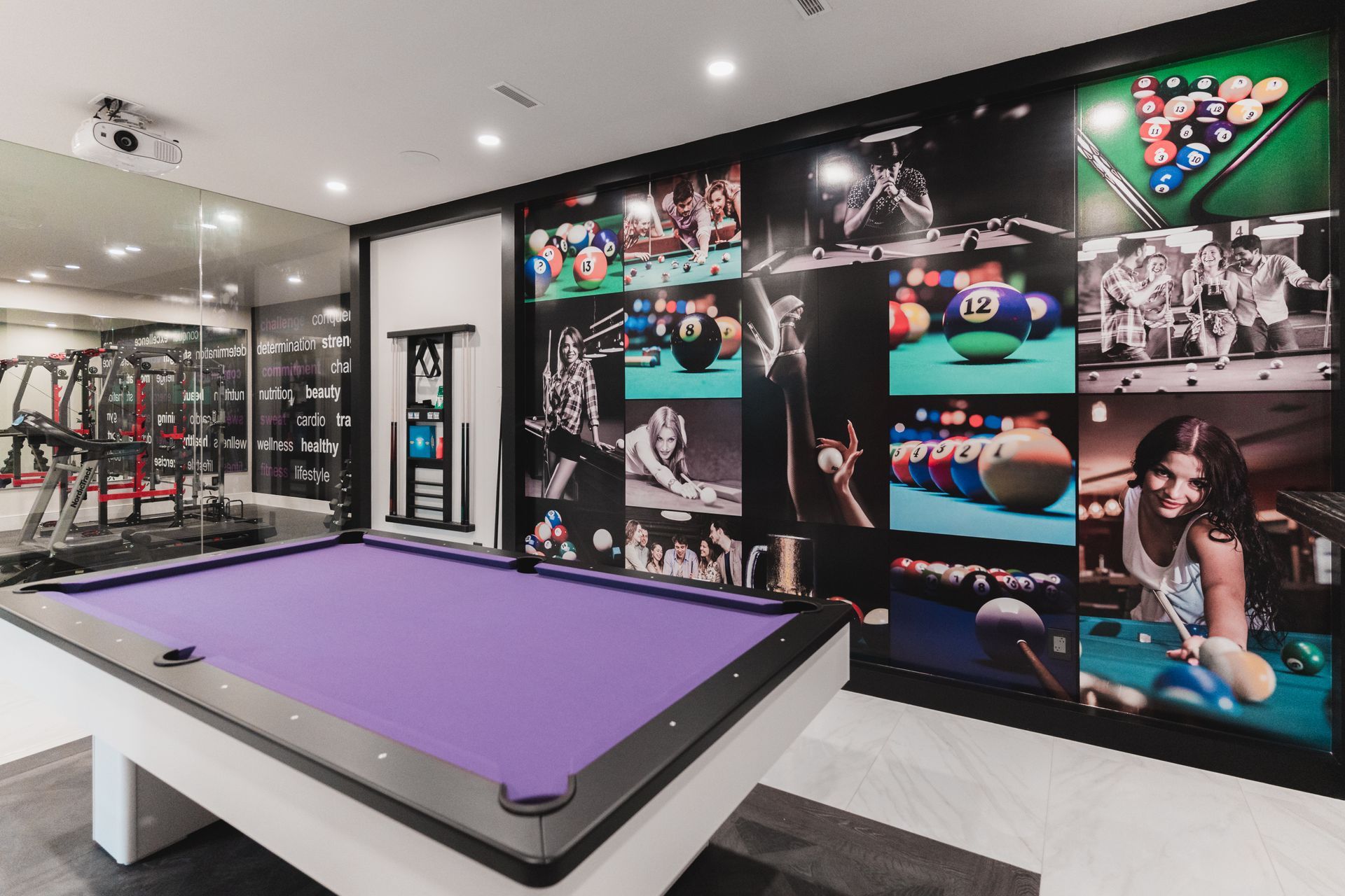 There is a pool table in the middle of the room.