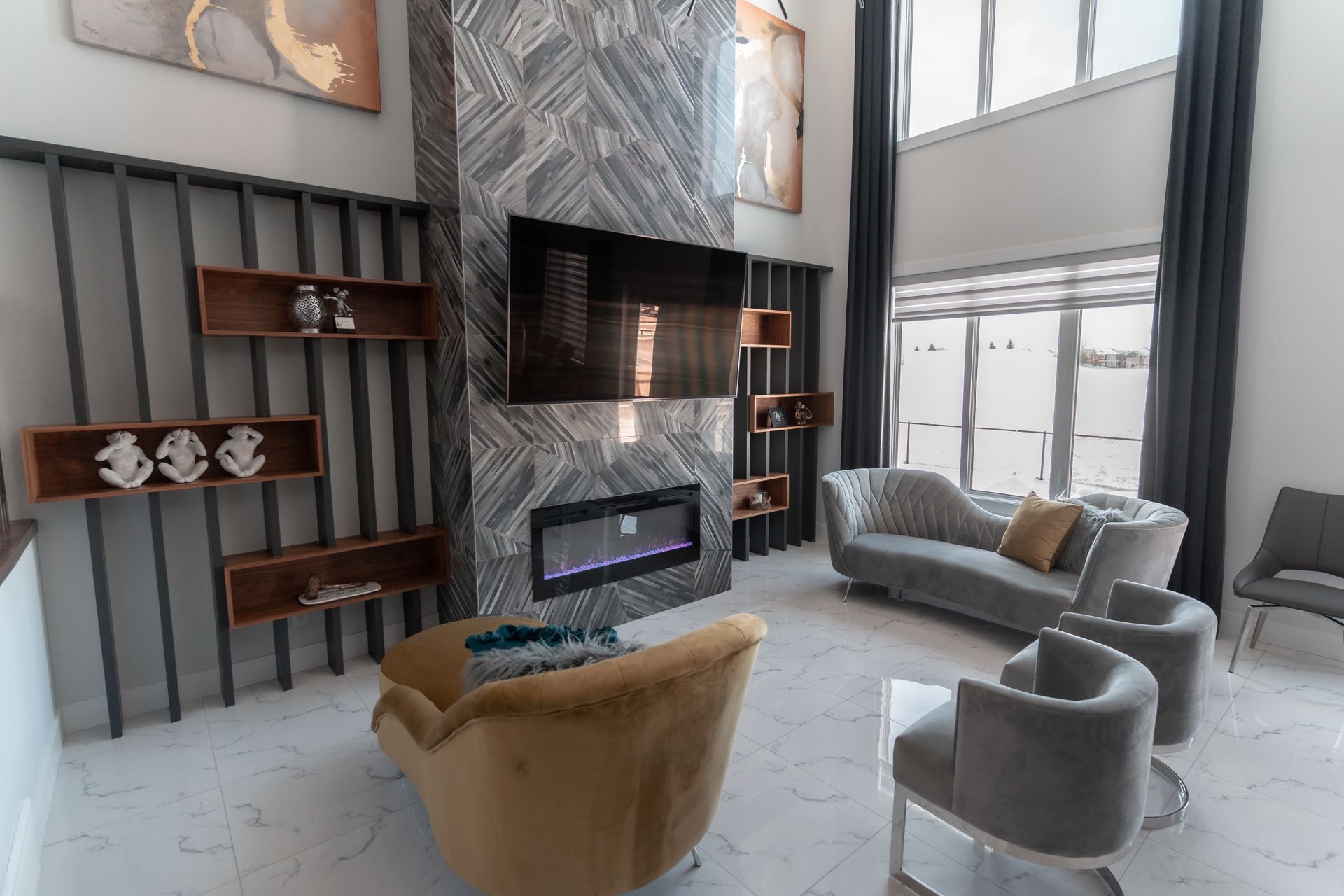 A living room with a couch , chairs , a fireplace and a flat screen tv.