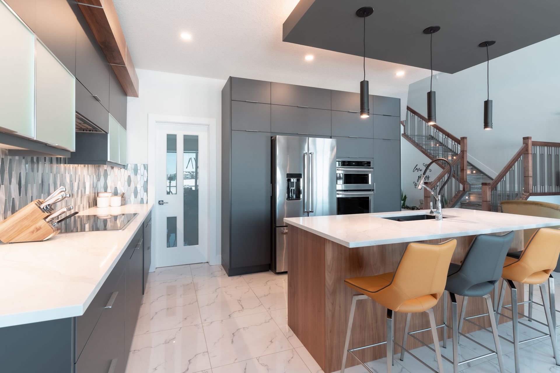 A kitchen with stainless steel appliances and a large island.