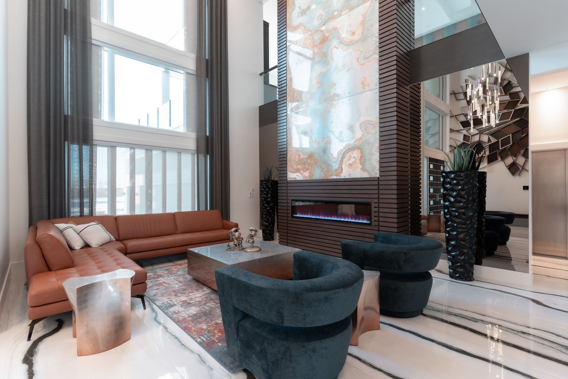 A living room with a couch , chairs , coffee table and fireplace.