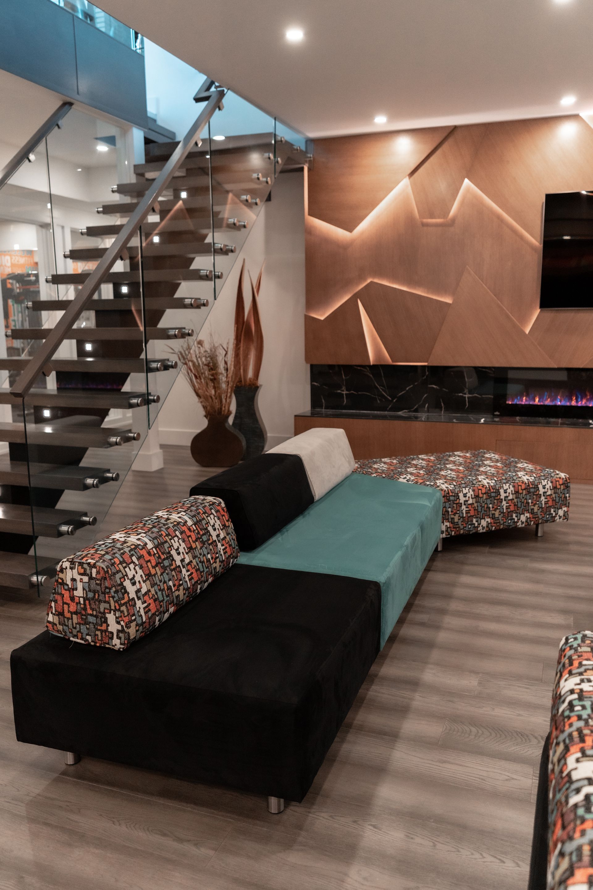 A living room with a couch and stairs in the background.