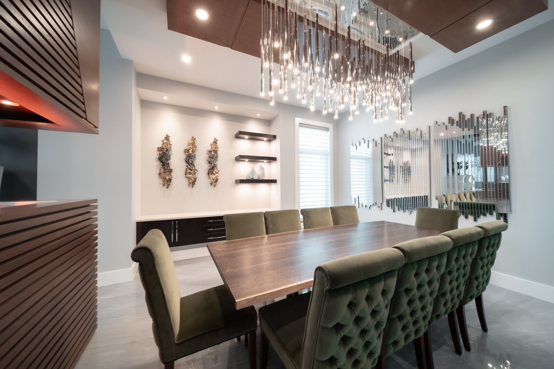 A dining room with a long table and chairs and a chandelier