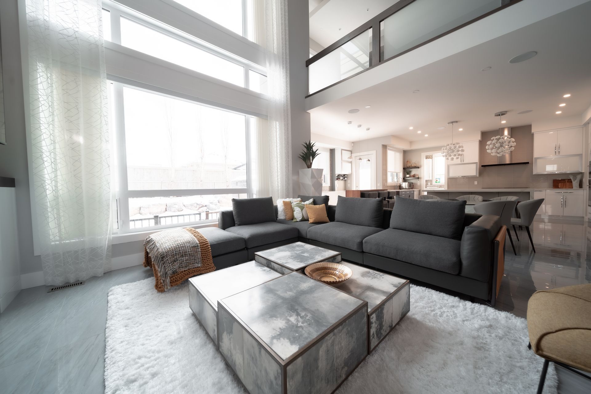A living room filled with furniture and a large window.