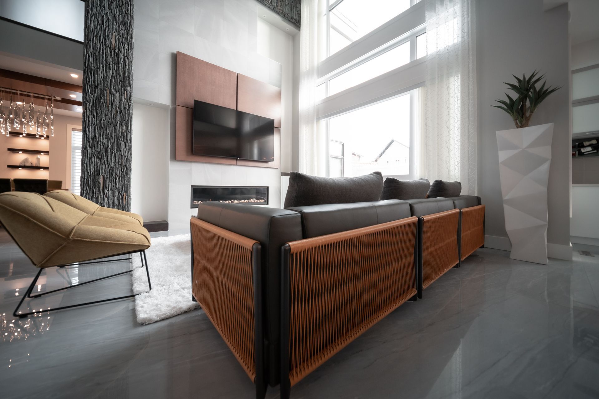 A living room with a couch a chair and a flat screen tv