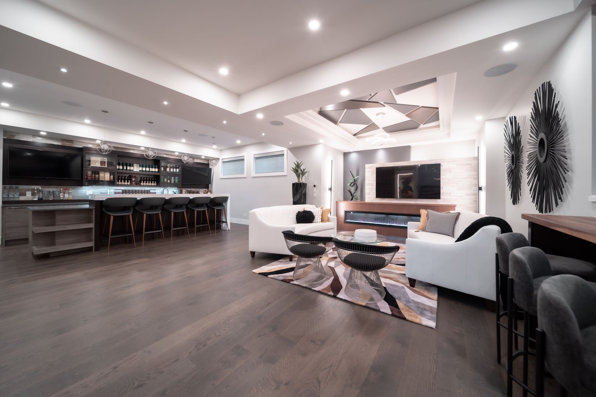 A living room filled with furniture and a television in a basement.