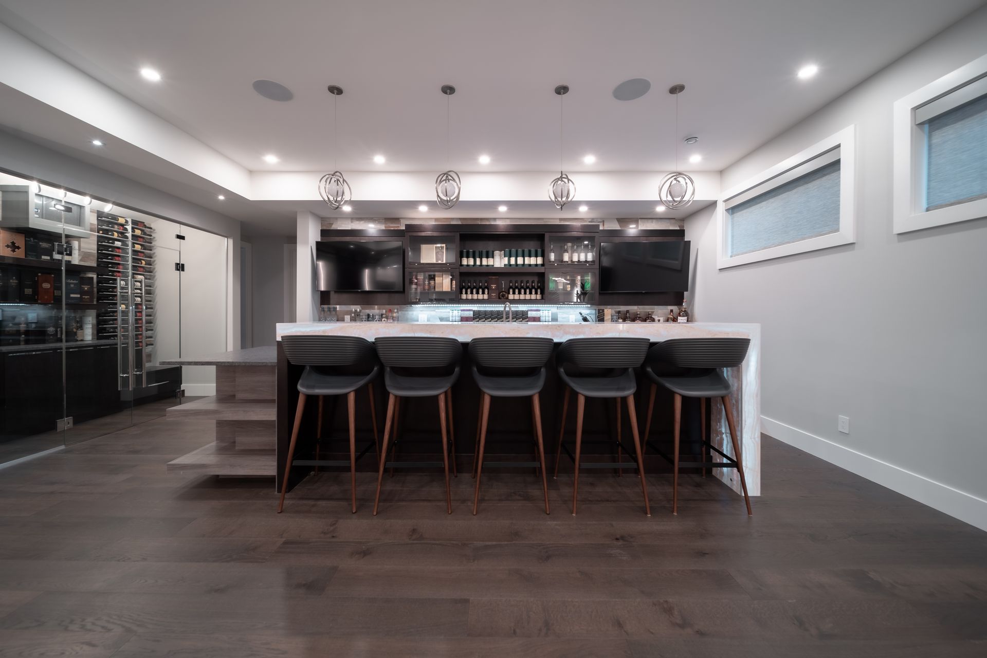 A kitchen with a bar and stools in it