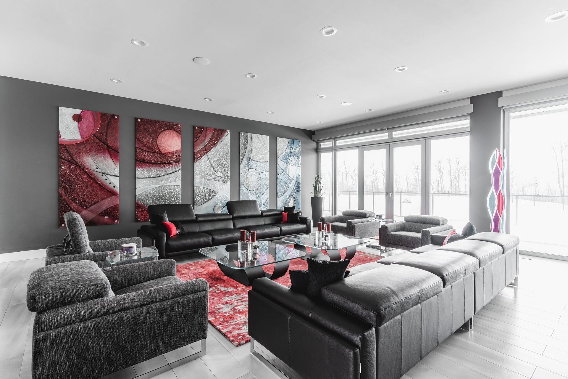 A living room with a lot of furniture and paintings on the wall.