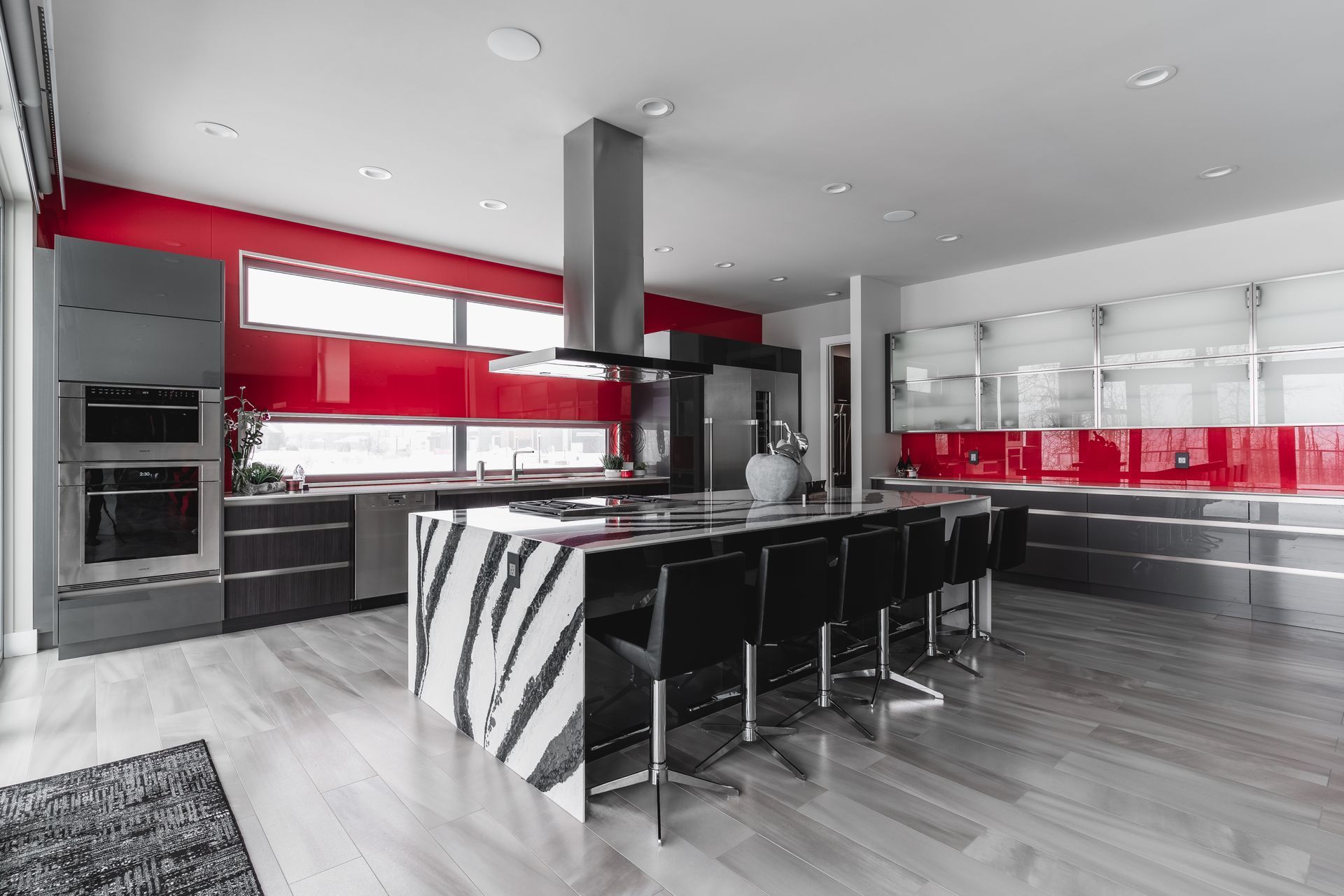 A black and white photo of a kitchen with a large island.