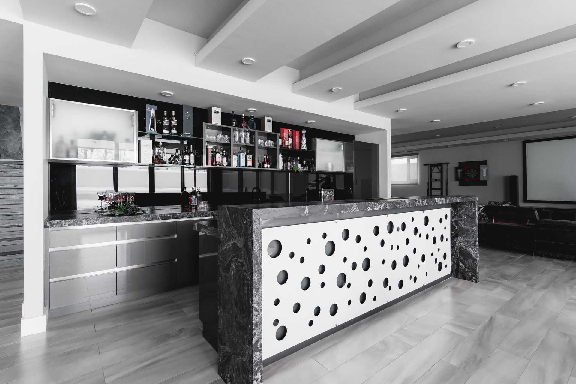 A black and white photo of a kitchen with a large island.